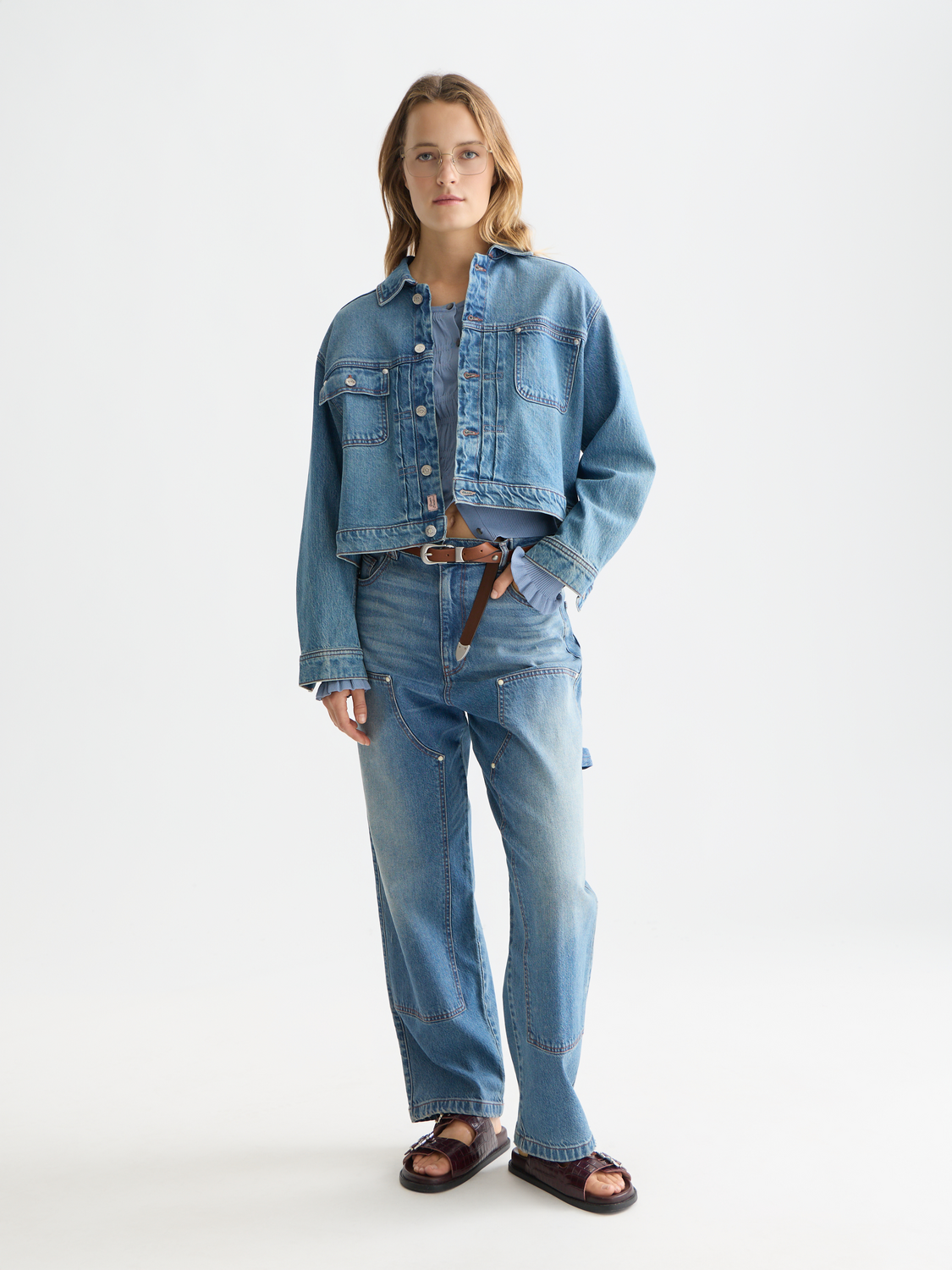 Scotch & Soda denim trucker jacket with classic button front and chest pockets, displayed on a mannequin.