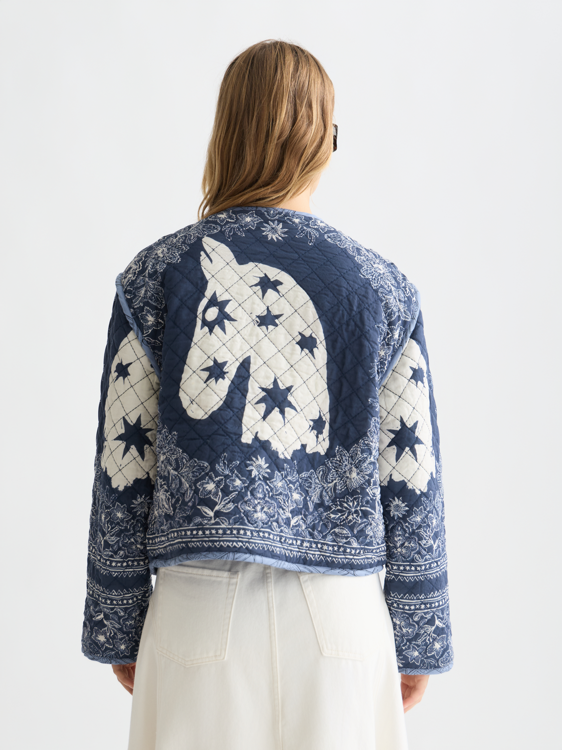 Reversible quilted bomber jacket by Scotch & Soda with a quilted design, shown from the back. Stylish and versatile outerwear.