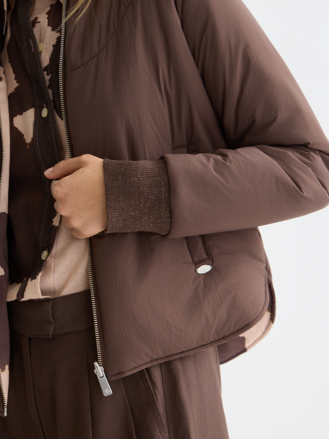 Reversible Scotch & Soda bomber jacket with color-block design, shown with one side featuring a solid color and the other side patterned.