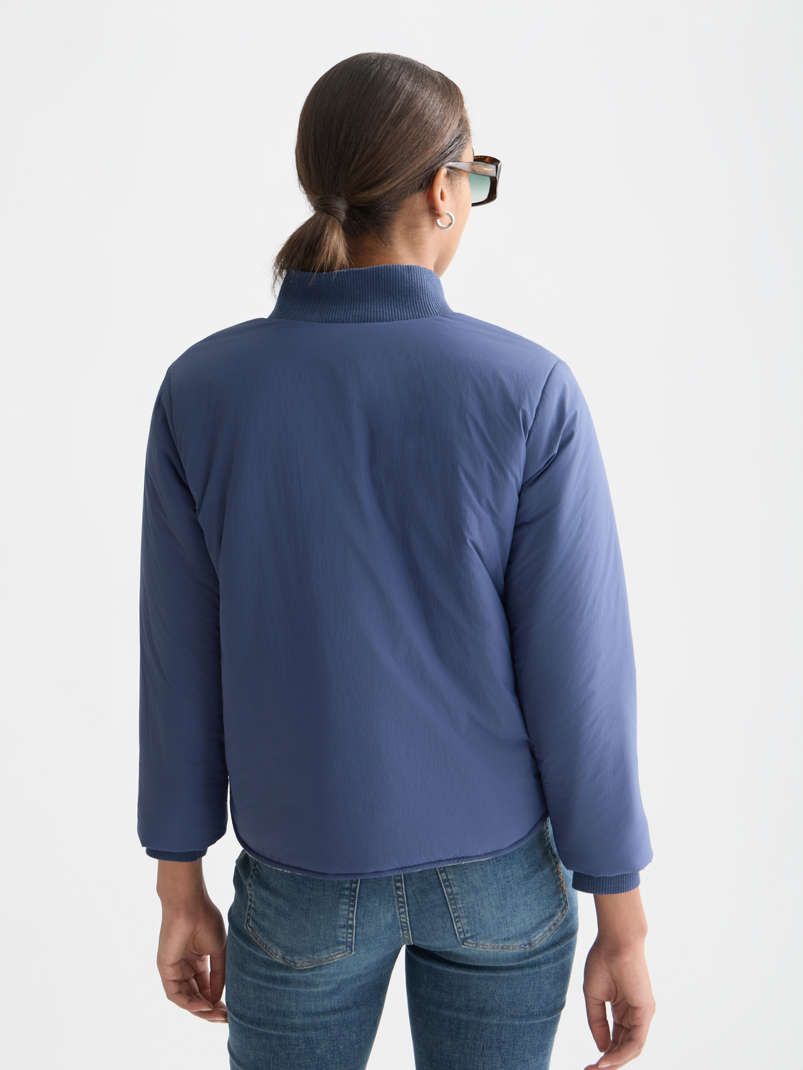 Reversible Scotch & Soda bomber jacket with black and printed fabric, shown from the back view.