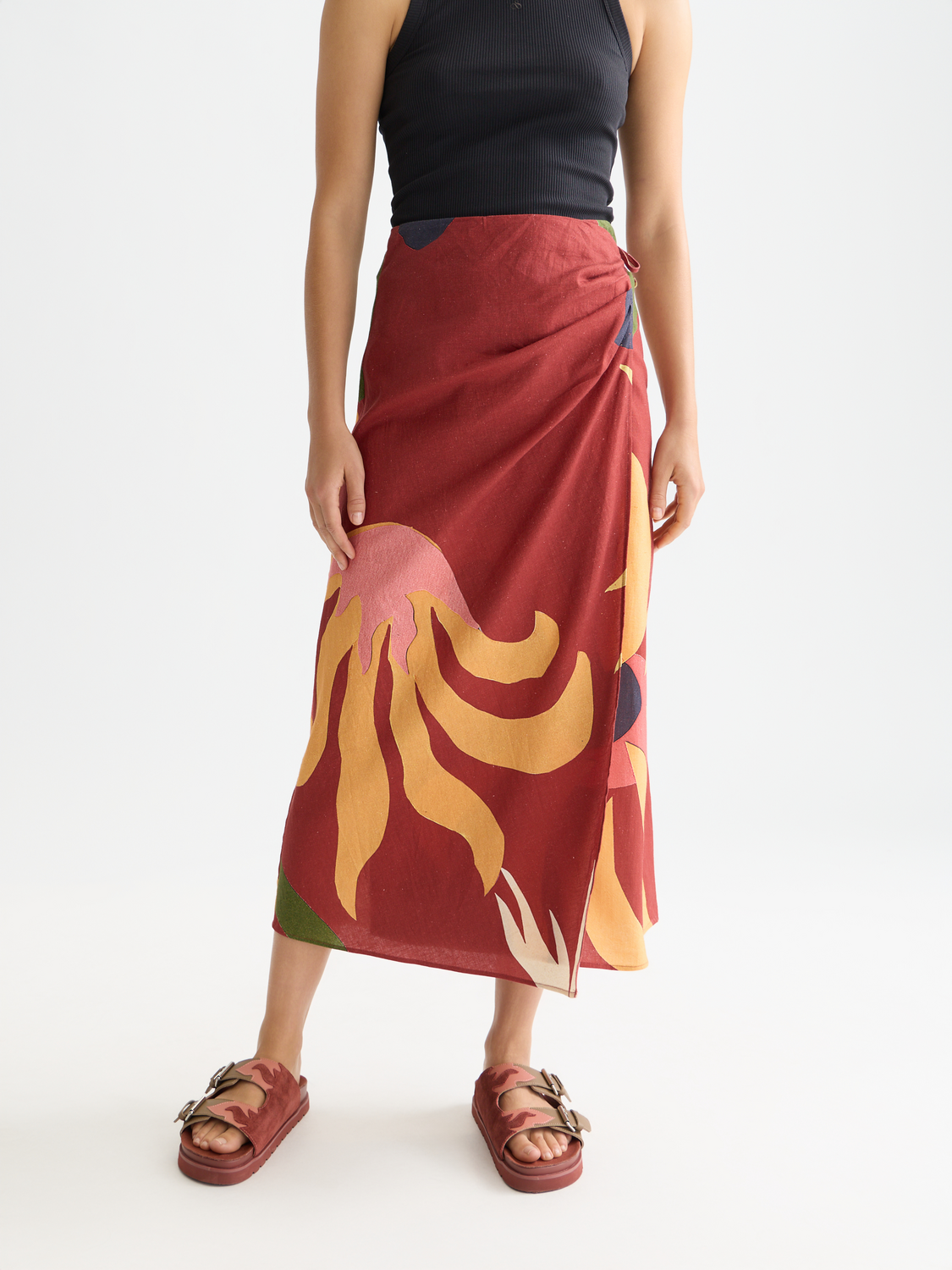 Linen wrap skirt by Scotch & Soda with a tied waist and flowing design, shown in a natural beige color.