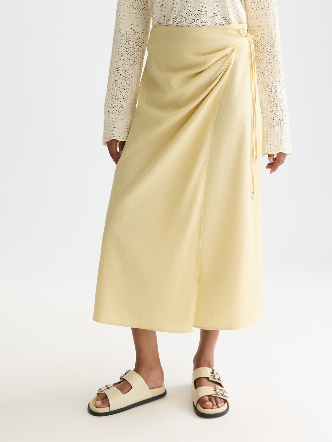 Linen wrap skirt by Scotch & Soda featuring a soft, neutral color and stylish design, perfect for casual or summer wear.
