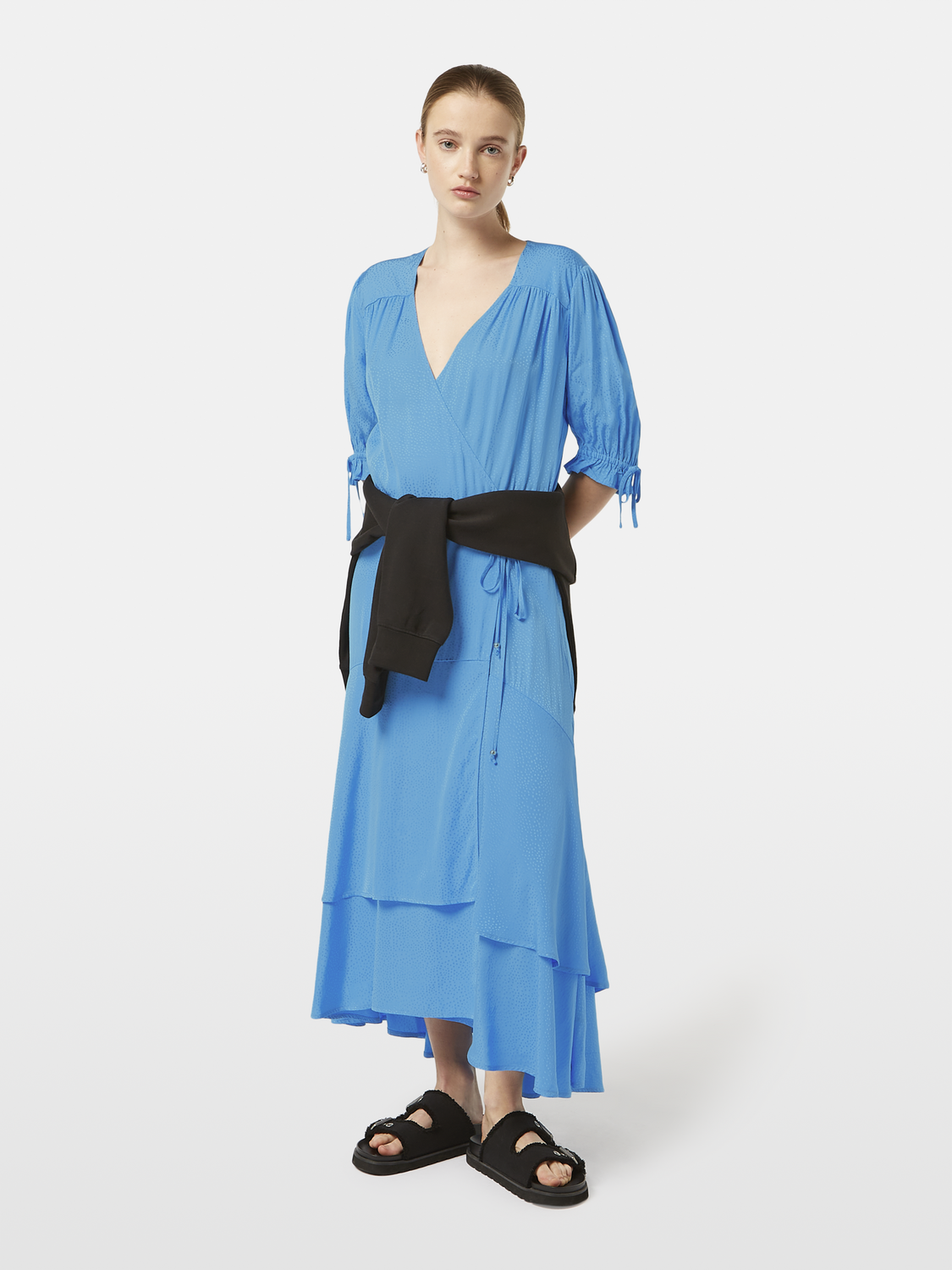 Scotch & Soda midi wrap dress featuring a floral pattern, V-neckline, and long sleeves, displayed on a hanger.