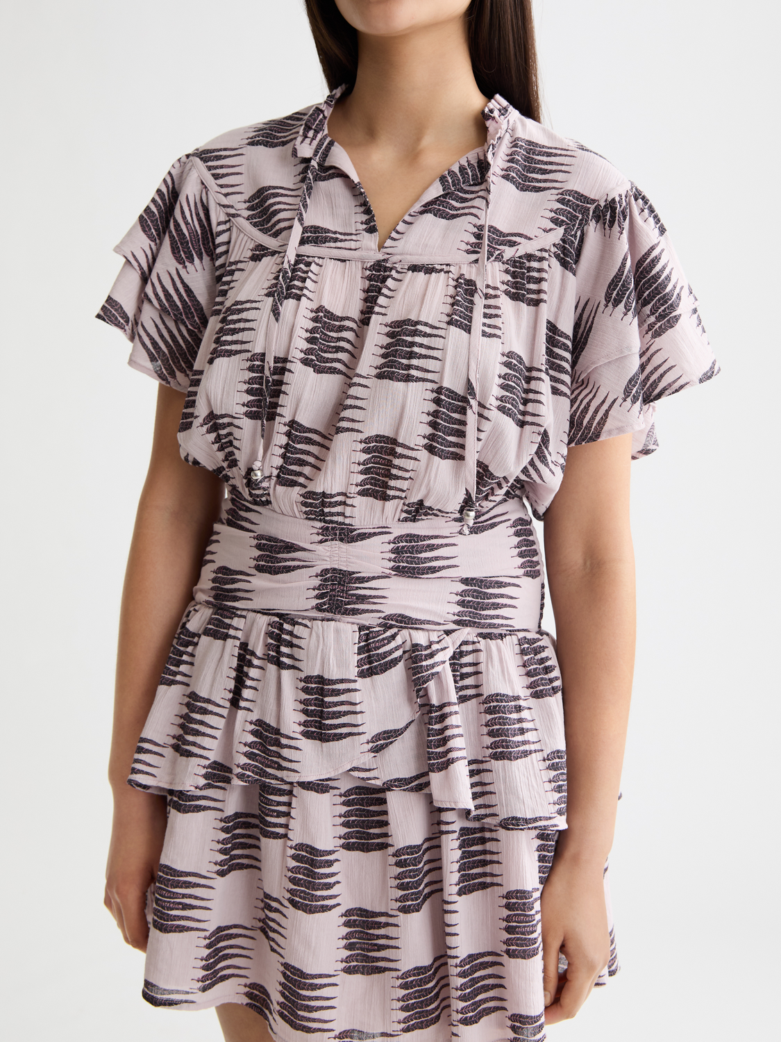 Light blue ruffled mini dress by Scotch & Soda featuring a fitted bodice and flared skirt, styled with short sleeves.
