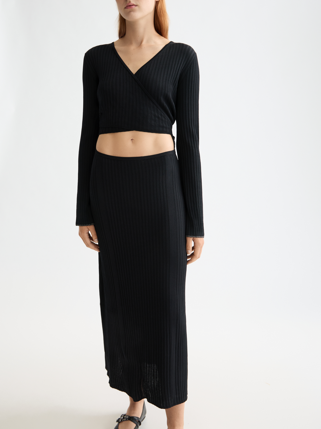 Ribbed wrap dress from Scotch & Soda, featuring a fitted silhouette and textured fabric, shown on a model.