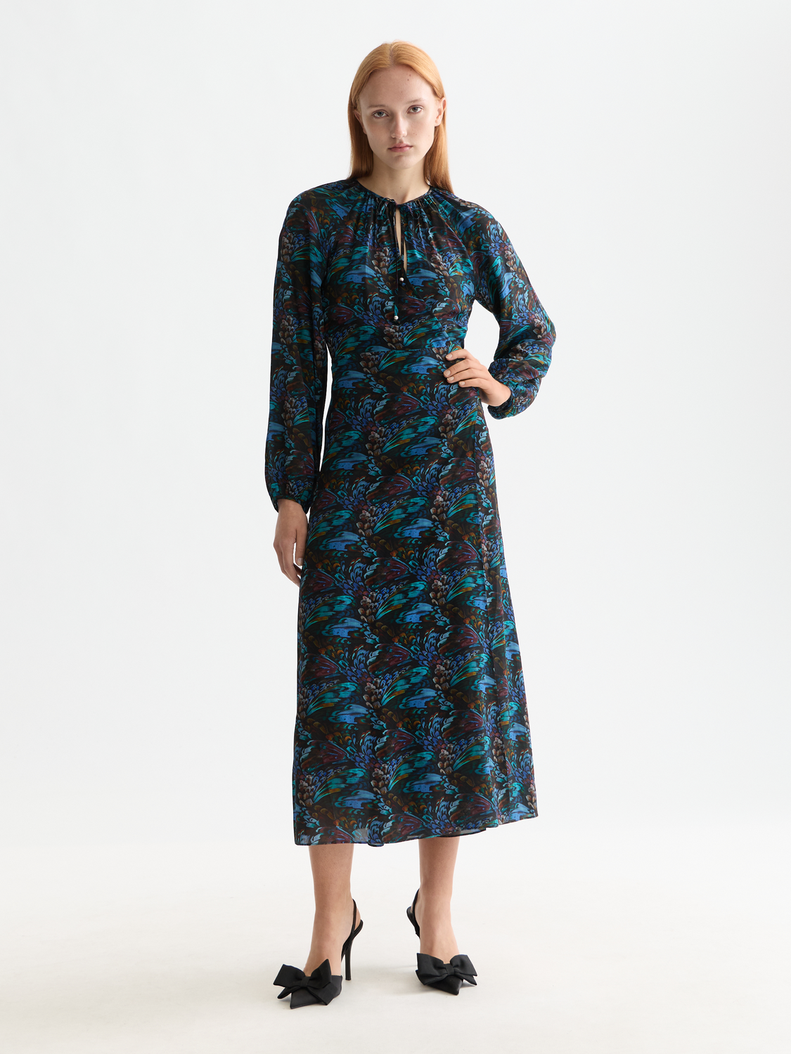 Scotch & Soda midi wrap dress with floral pattern, V-neckline, and long sleeves, displayed on a model.