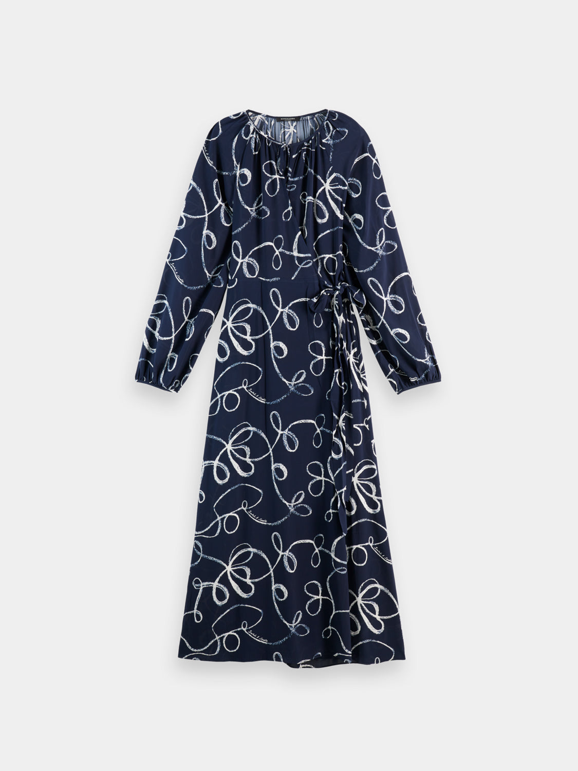 Scotch & Soda midi wrap dress featuring a floral pattern and V-neck, shown on a model with a relaxed, elegant style.