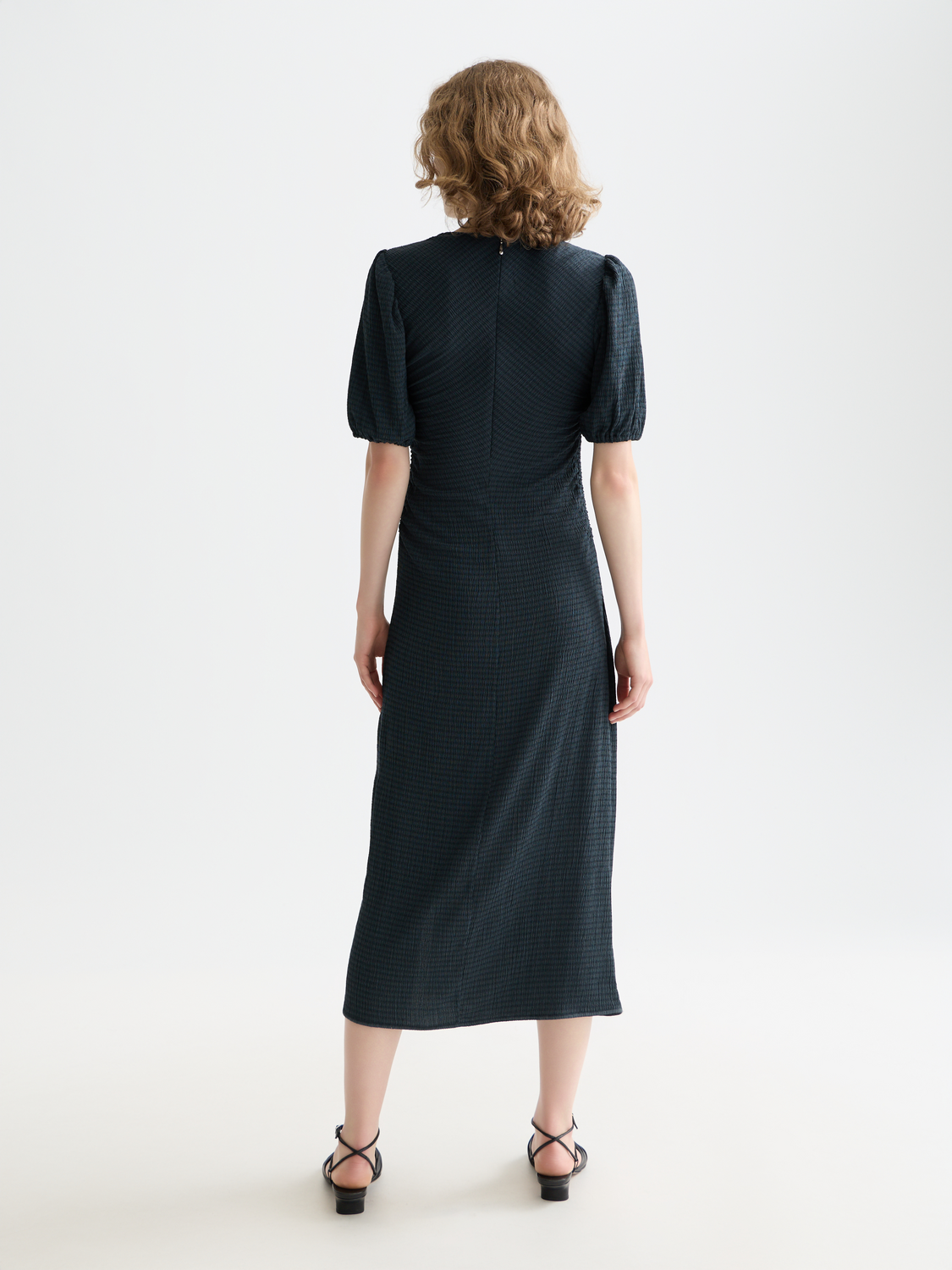 Black gathered midi dress by Scotch & Soda, showcasing a stylish, flowing design with gathered fabric and a midi length.