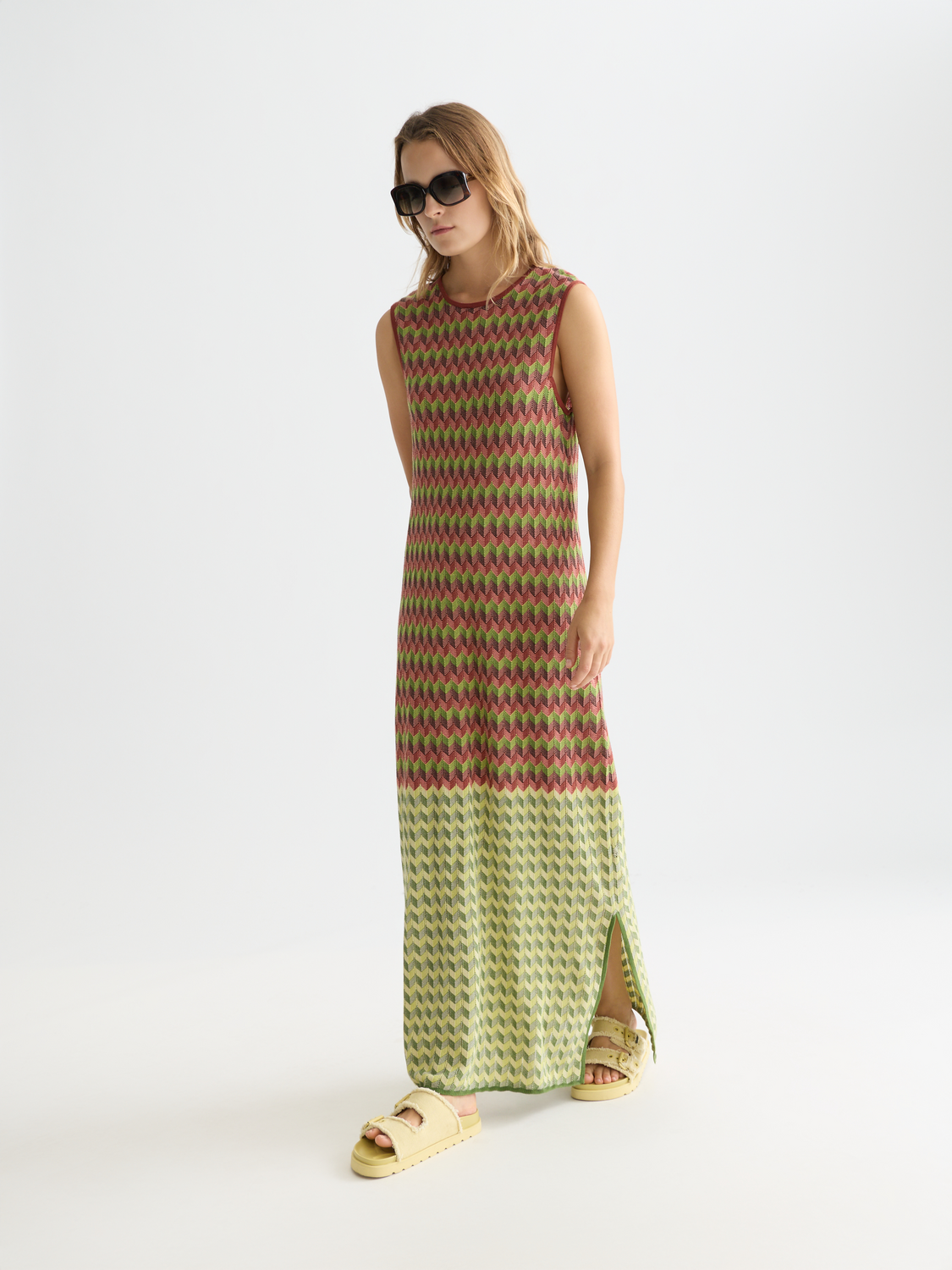 Scotch & Soda knitted maxi dress featuring a fitted bodice, long sleeves, and a flowing skirt in soft, textured fabric.