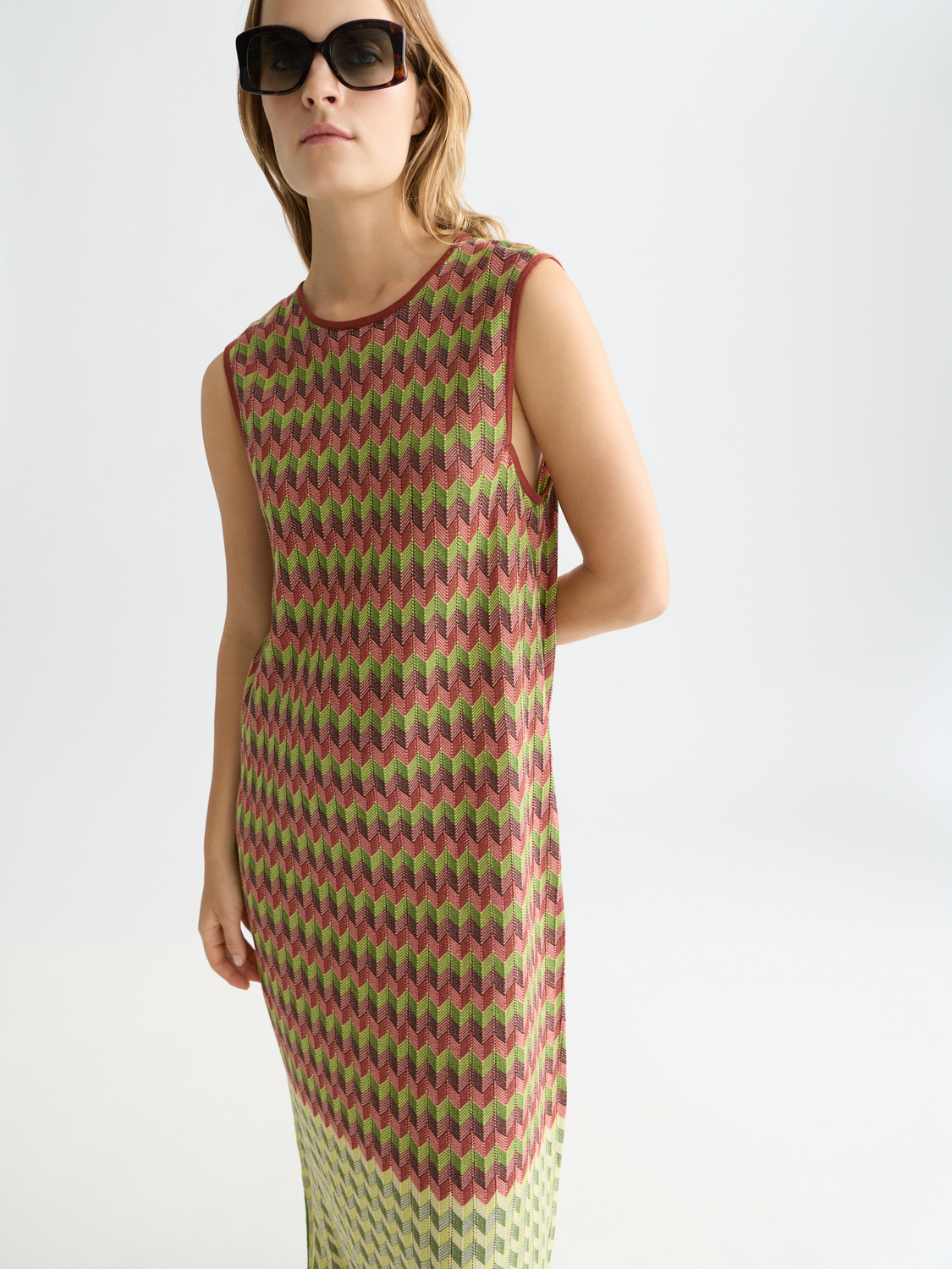 Knitted maxi dress by Scotch & Soda featuring a long, flowing silhouette and intricate knit pattern in neutral tones.