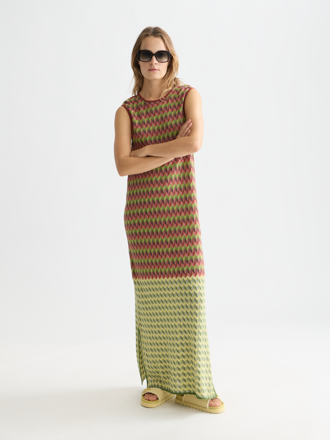 Knitted maxi dress by Scotch & Soda featuring a fitted bodice and flowing skirt, modeled in a front view.