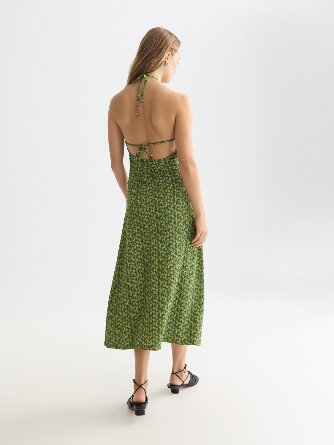 Black open-back midi dress by Scotch & Soda, featuring a flowing silhouette and stylish design, perfect for elegant occasions.