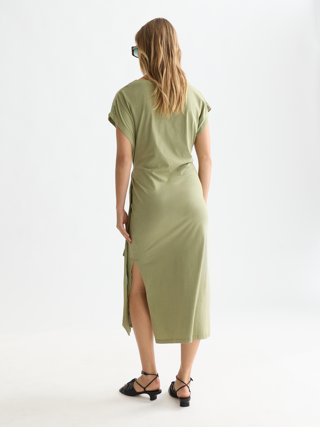 Black knotted midi dress by Scotch & Soda featuring a stylish, fitted silhouette and elegant design.