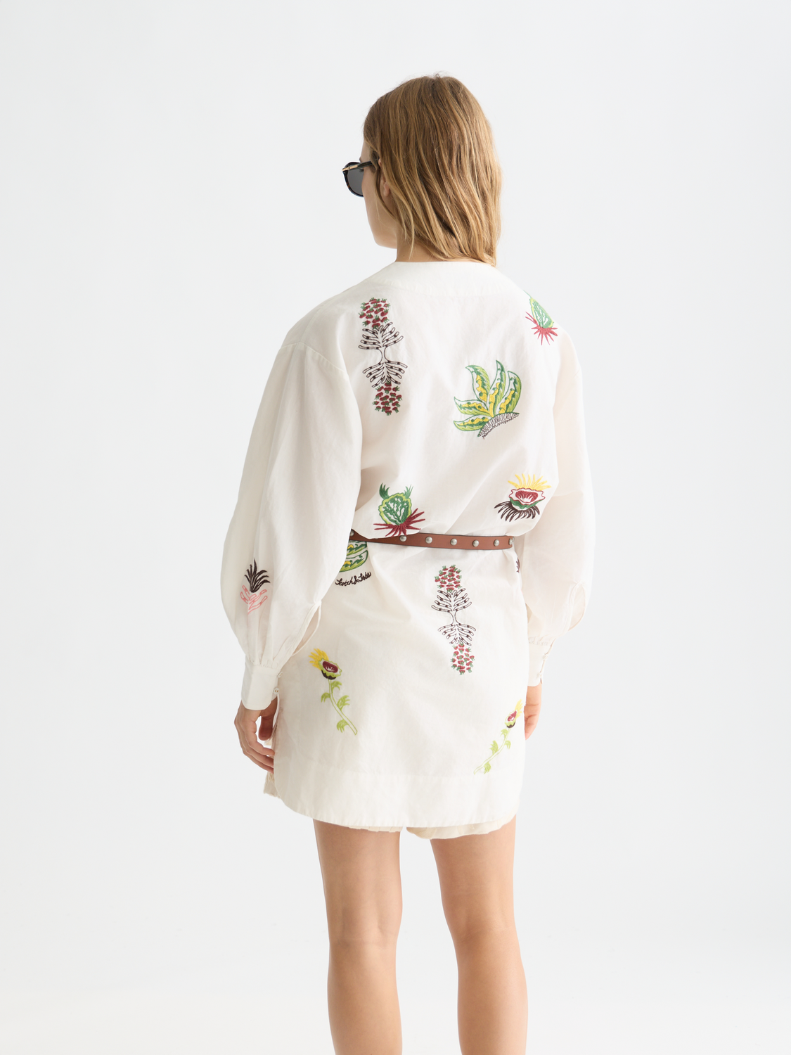 Black embroidered mini dress by Scotch & Soda, featuring intricate floral embroidery and a fitted silhouette.