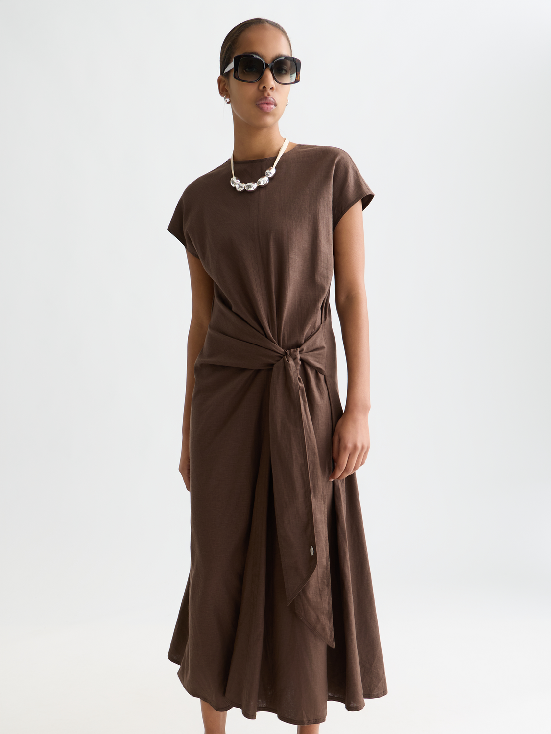 Linen-blend tie dress by Scotch & Soda, featuring a relaxed fit, tie waist, and casual style, shown on a model.