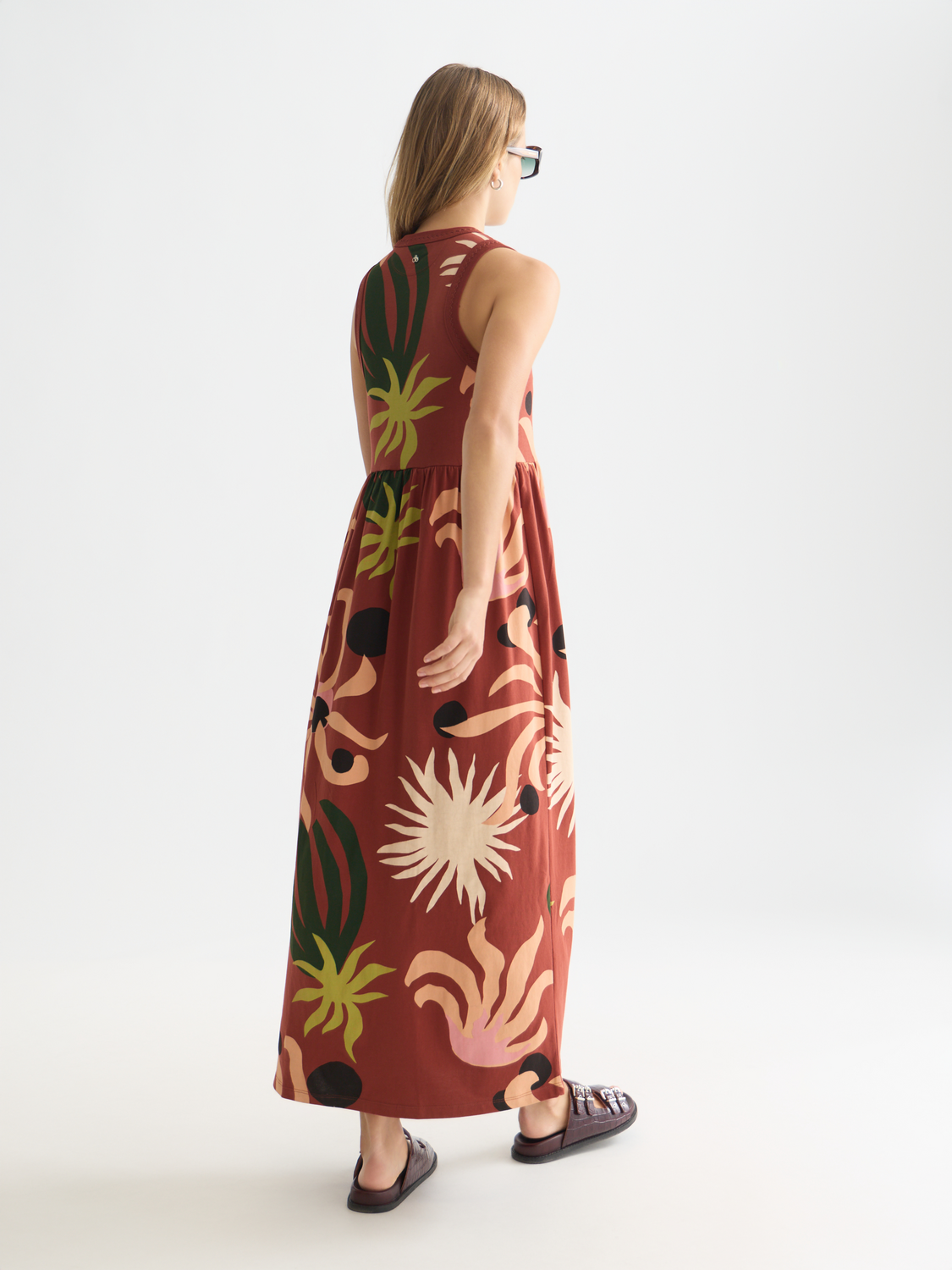 Black printed tank midi dress by Scotch & Soda, sleeveless design with floral pattern, flowing fabric, and round neckline.
