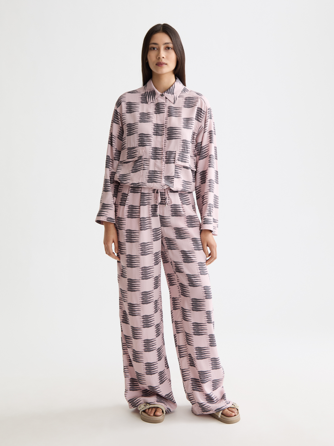 Wide-fit Eleni pants by Scotch & Soda in a neutral color, shown on a model with a relaxed, stylish fit and high waist.