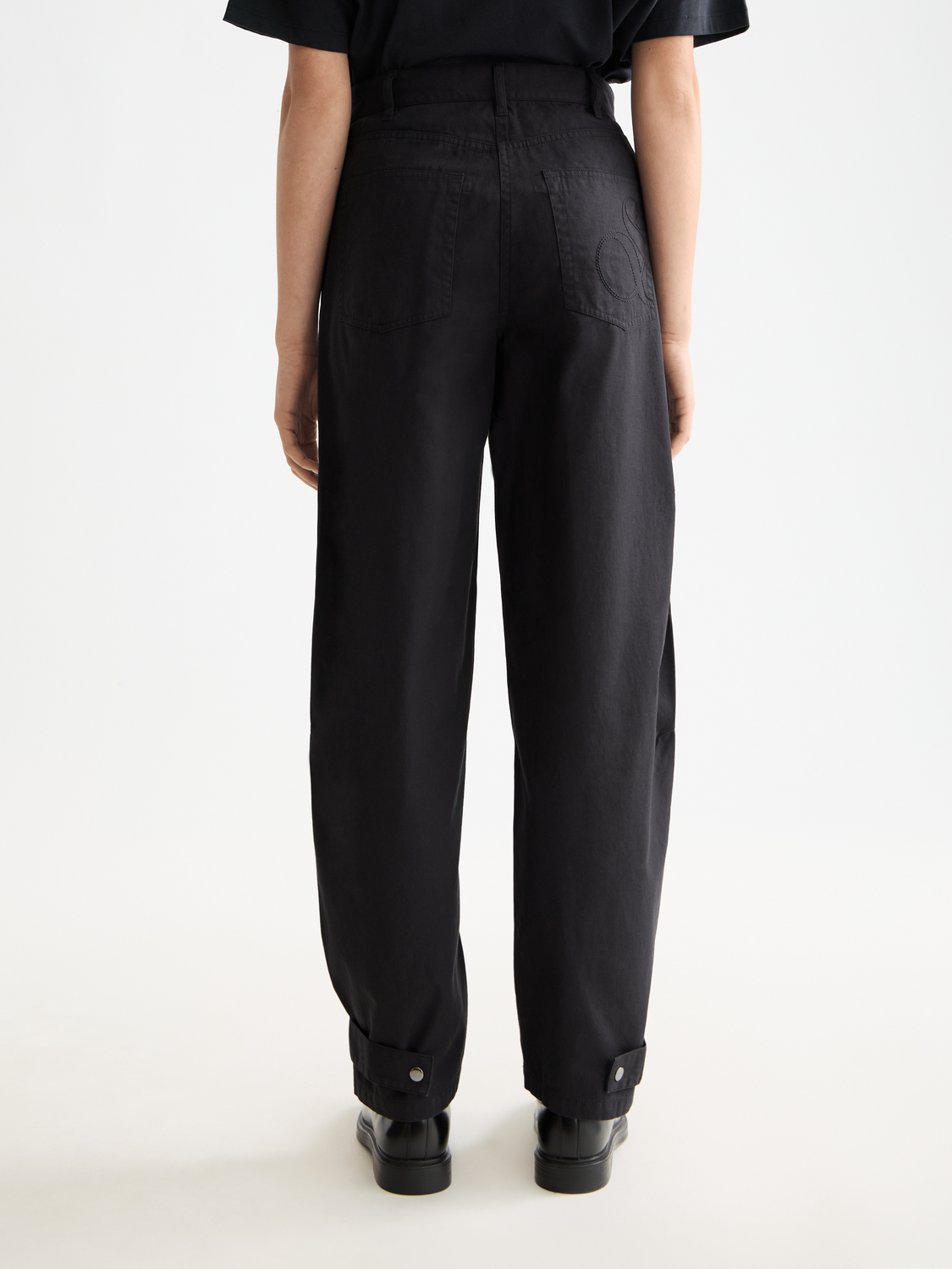 Black Lotus barrel leg pants by Scotch & Soda with a relaxed fit and wide leg design, shown on a model.