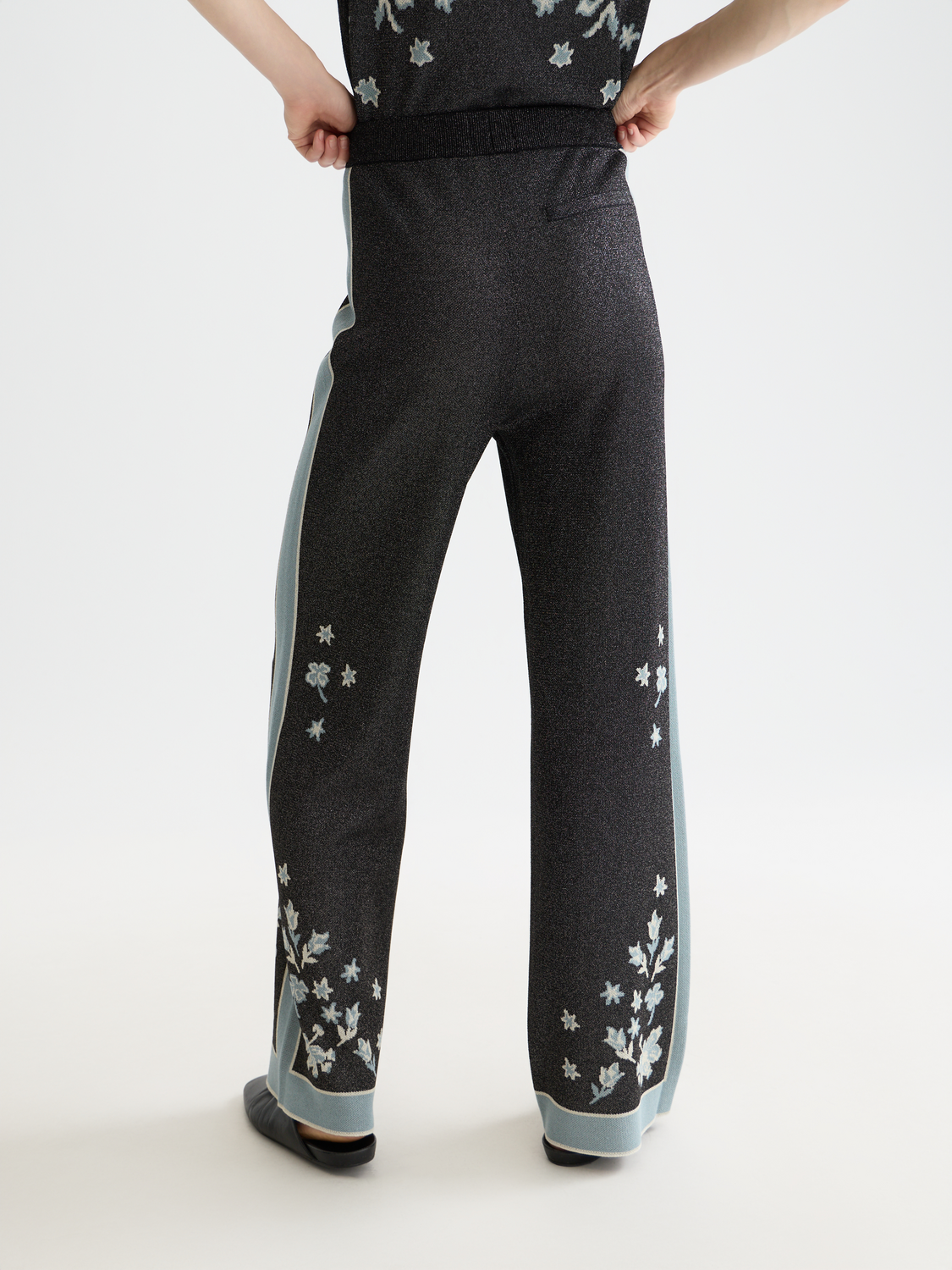 Jacquard knitted sweatpants by Scotch & Soda, showing the back view with detailed woven pattern and relaxed fit.