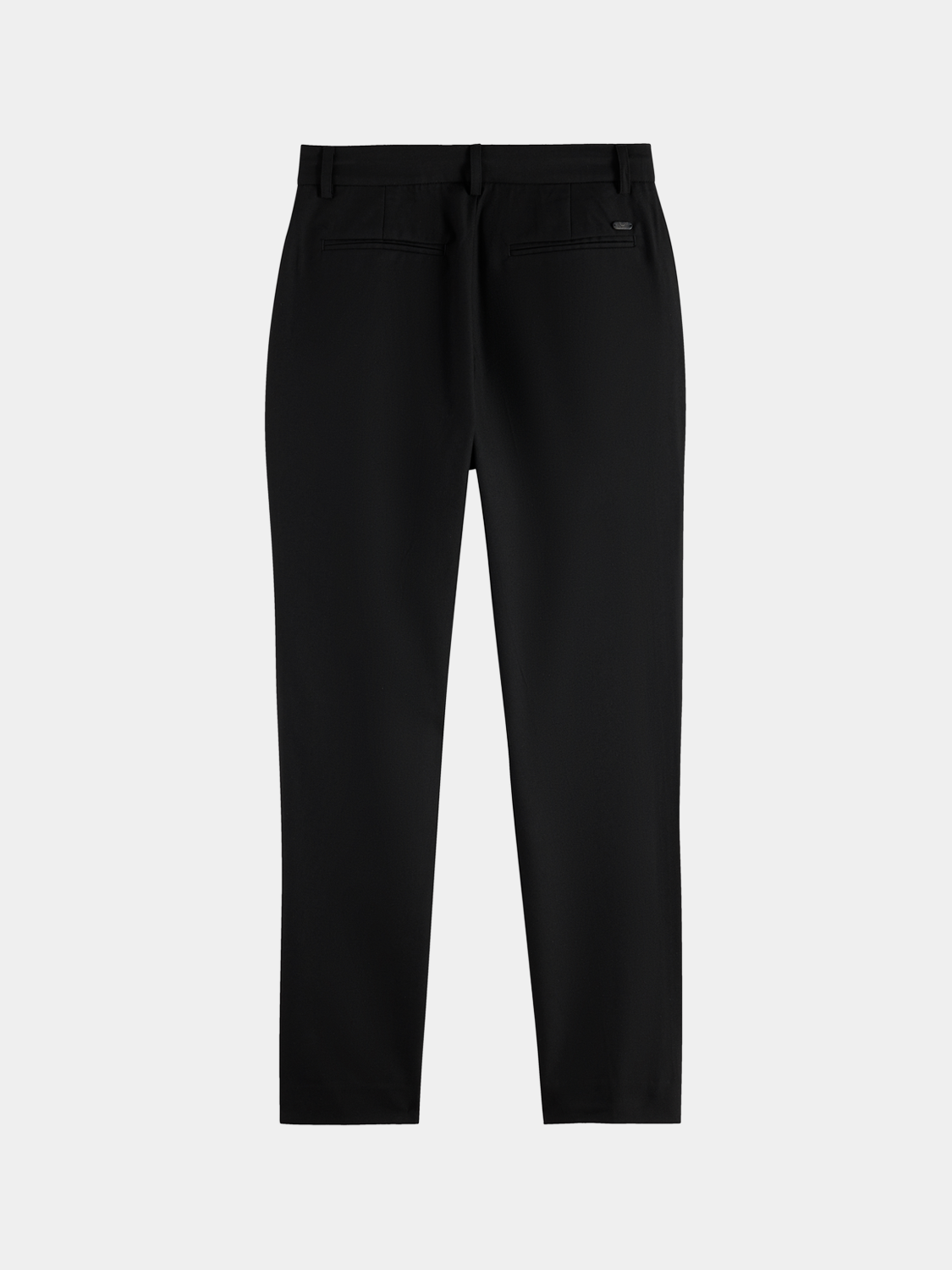 Black Lowry slim-fit pants by Scotch & Soda displayed on a model with hands in pockets, showcasing modern, tailored style.