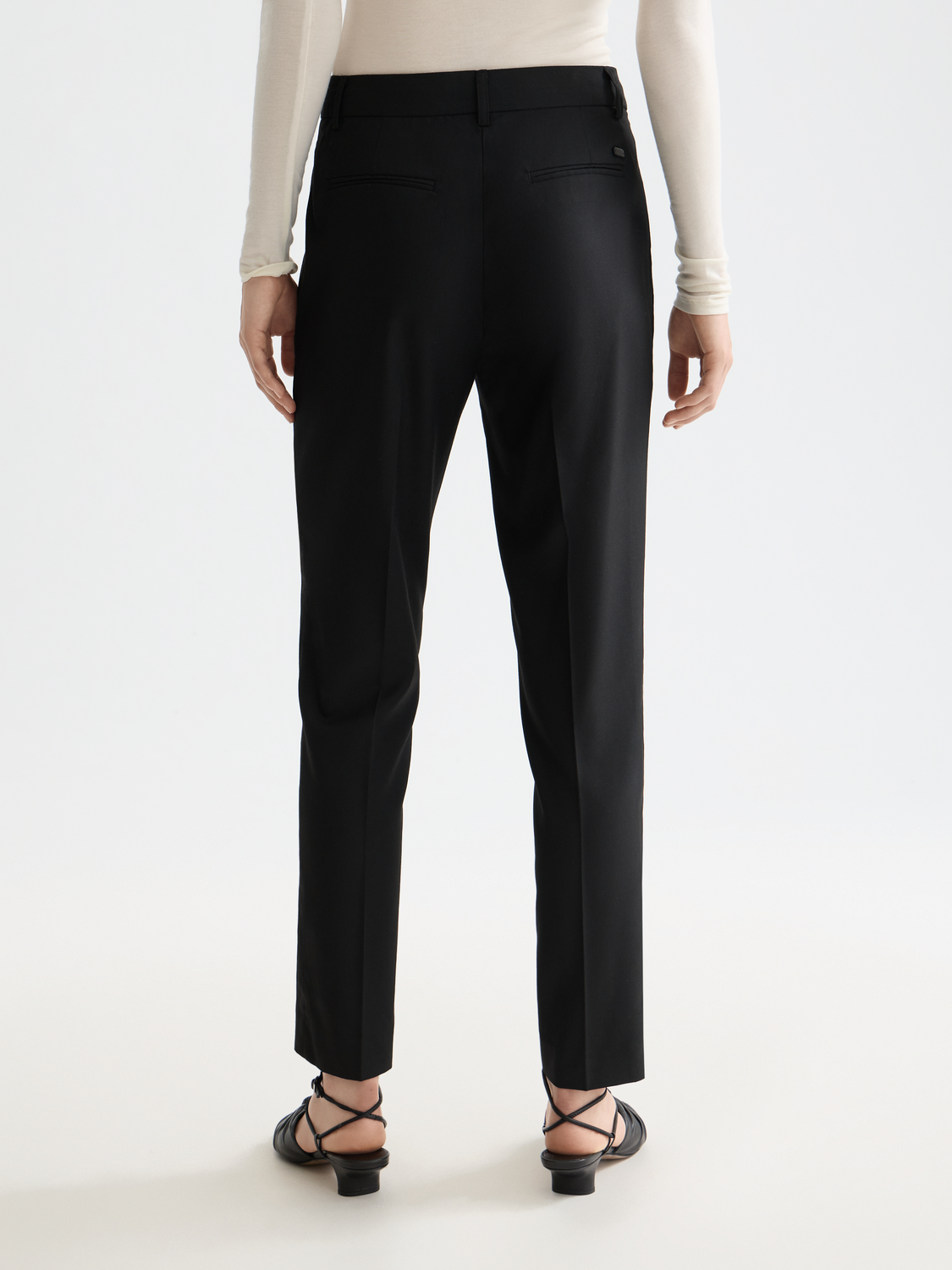 Scotch & Soda Lowry slim-fit pants in dark fabric, shown from back view with tailored design and subtle stitching details.