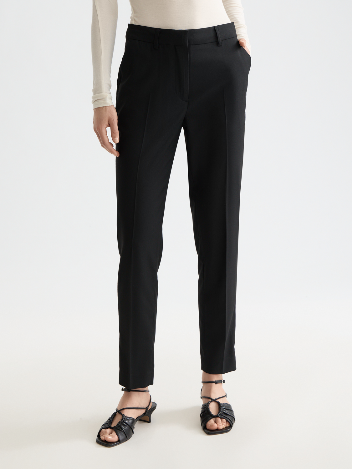 Slim-fit Lowry pants by Scotch & Soda, shown in dark color, with front view highlighting tailored fit and classic design.