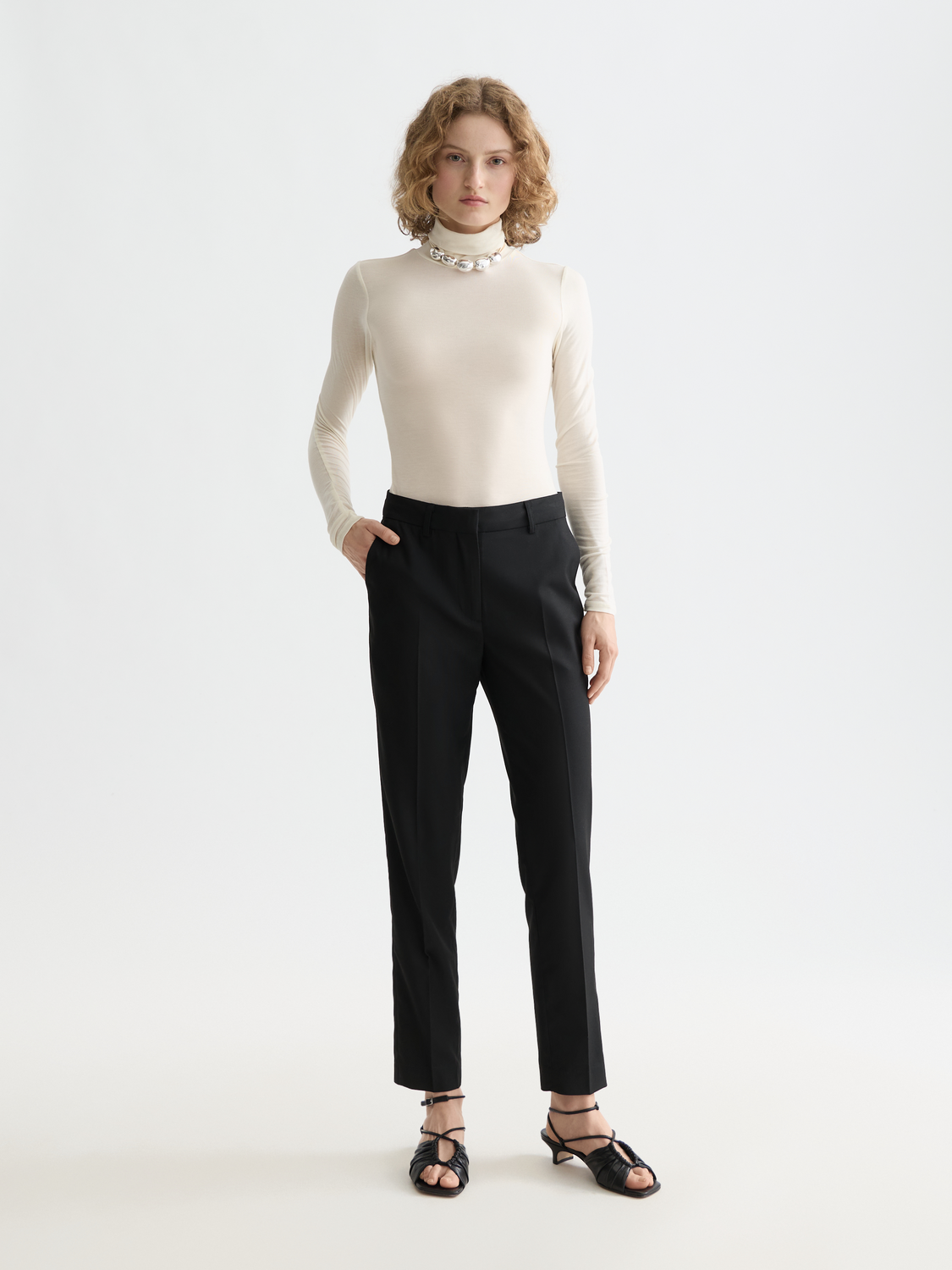 Slim-fit Lowry pants by Scotch & Soda, featuring a tailored design in a neutral color, displayed on a model.