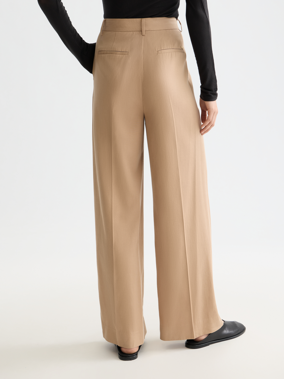 Wide-fit rose-colored pants by Scotch & Soda, featuring a relaxed fit and stylish design, shown from the back angle.