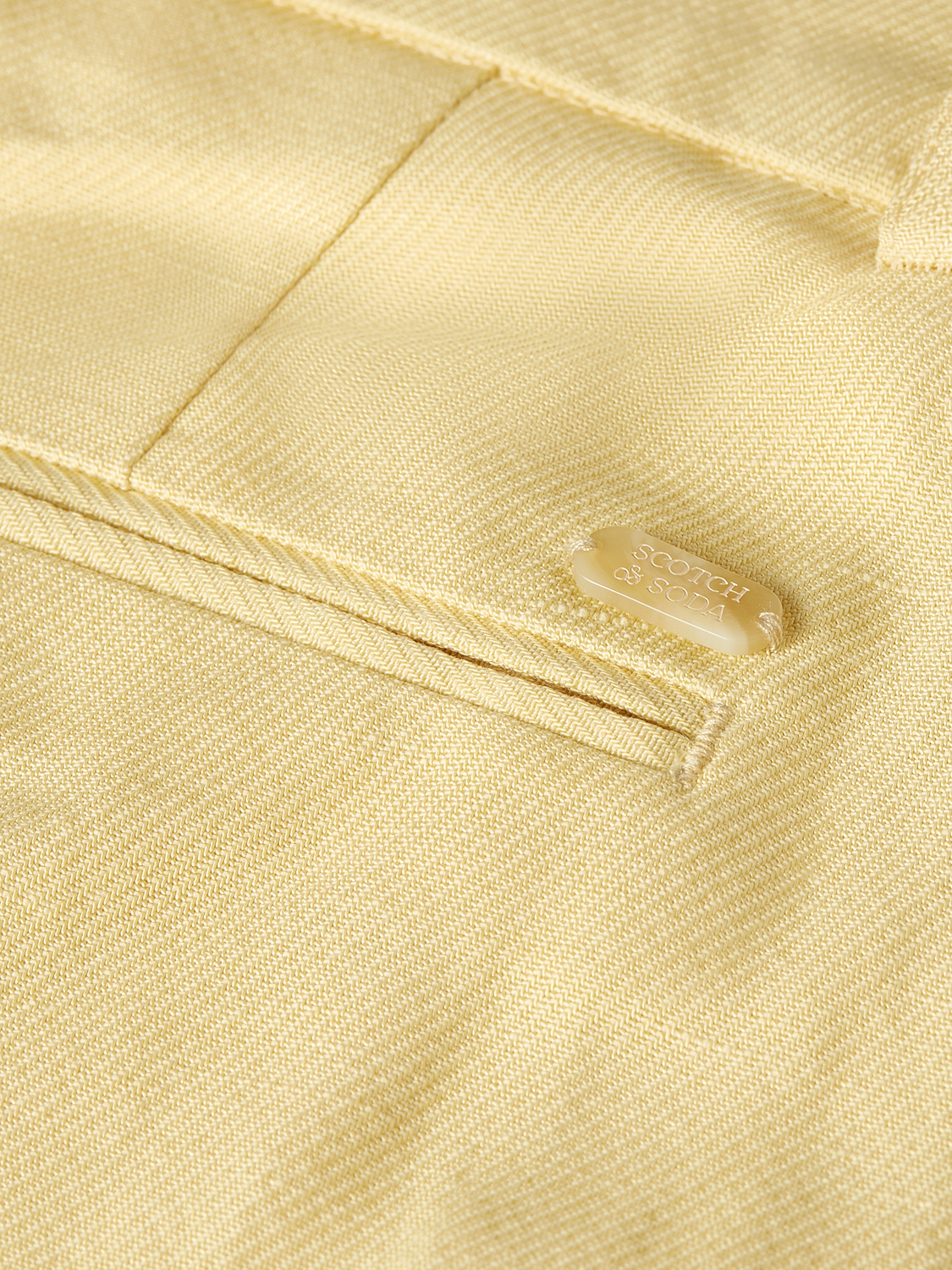 Wide-fit Edie pants by Scotch & Soda, featuring a relaxed silhouette and stylish detailing, shown in a neutral fabric.