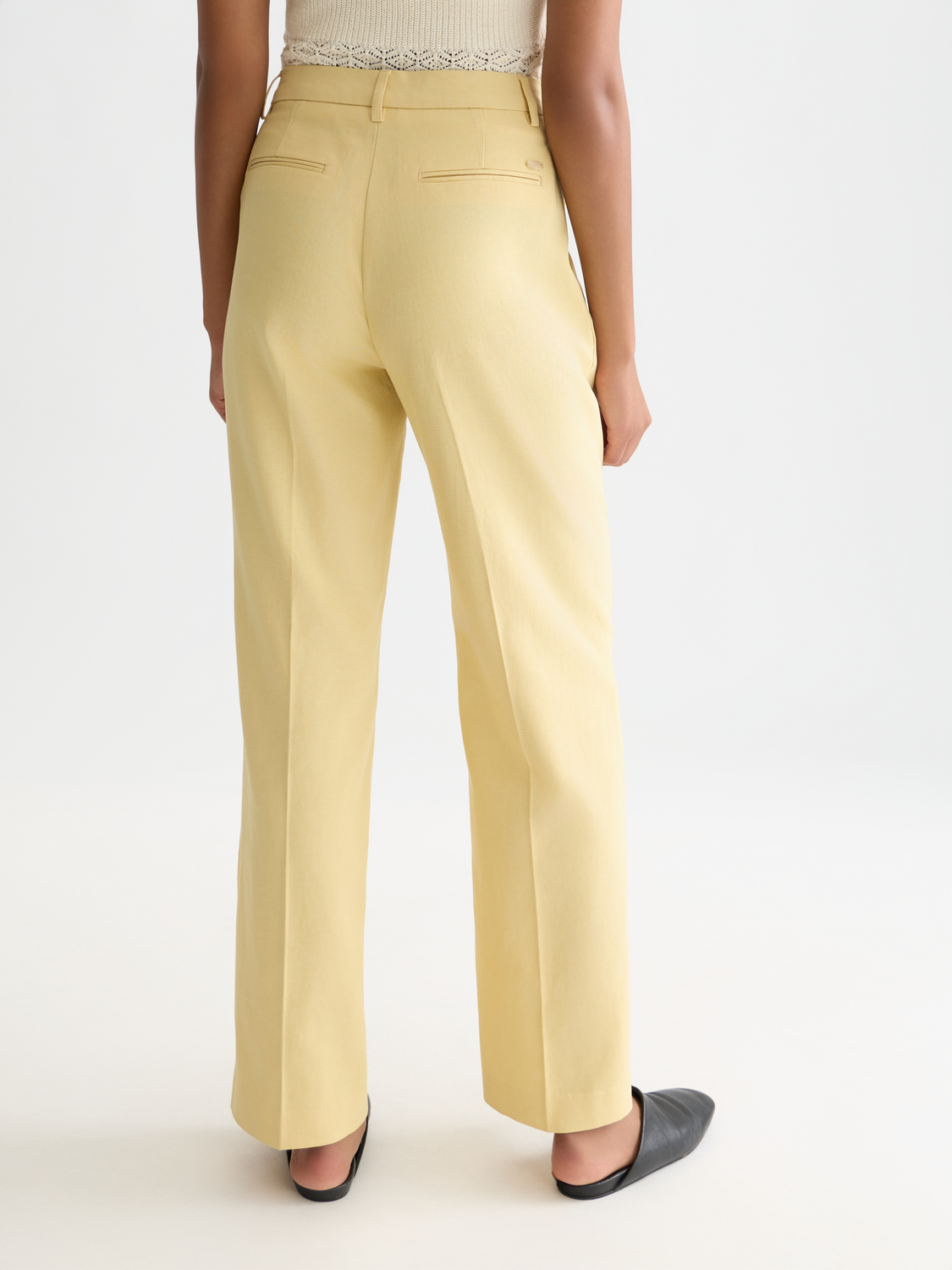 Wide-fit Edie pants by Scotch & Soda, showcasing their relaxed fit and stylish design from the back view.