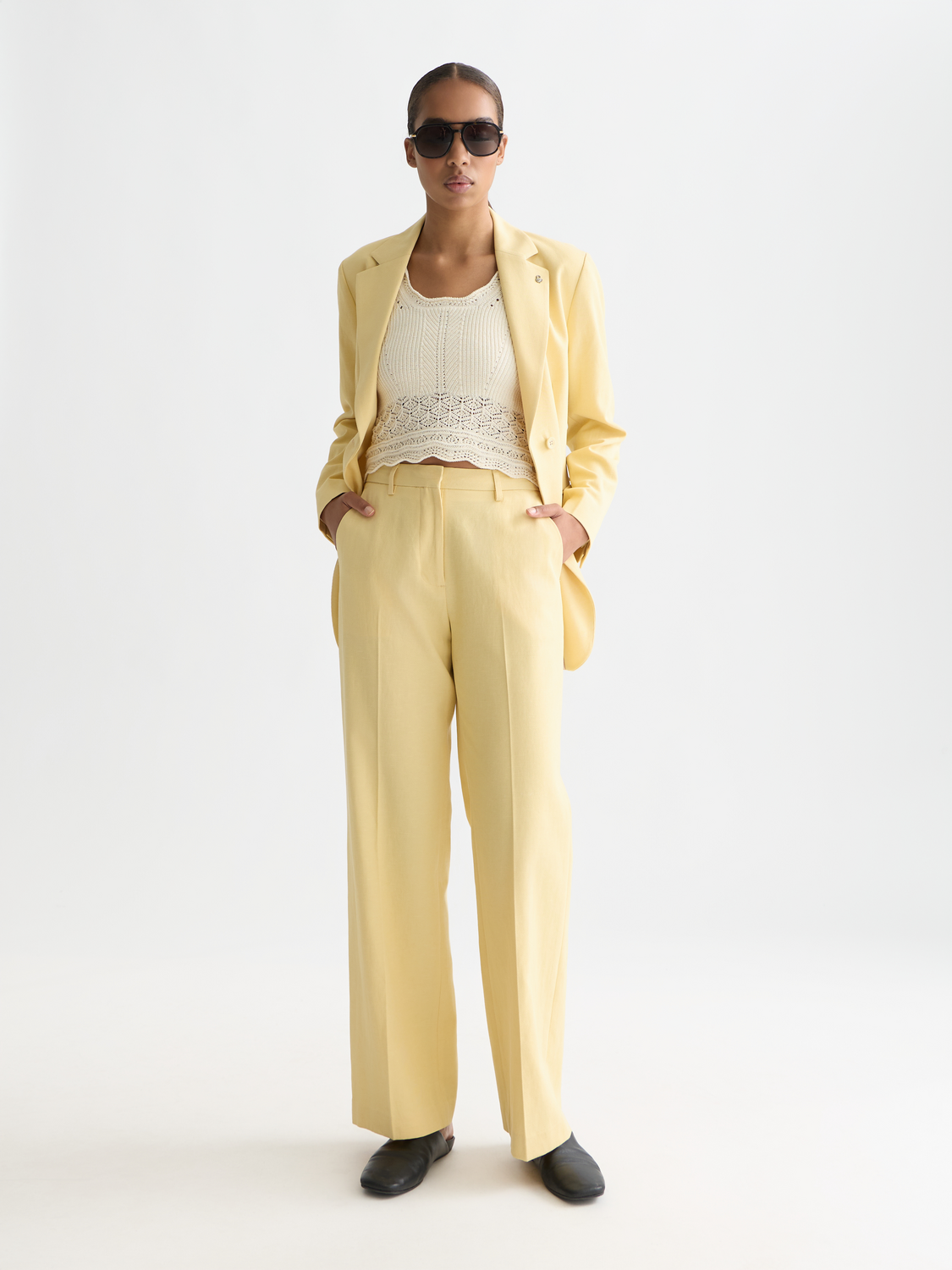 Wide-fit Edie pants by Scotch & Soda, featuring a relaxed silhouette and stylish design, shown in a neutral color.