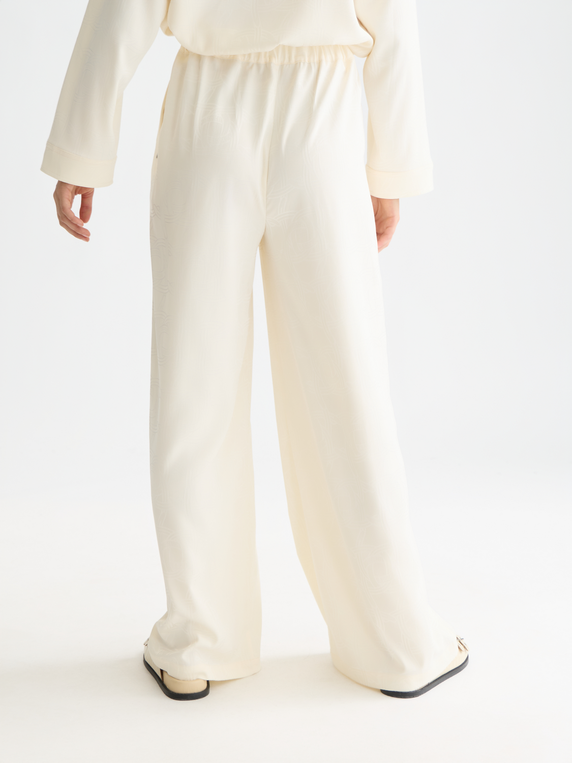 Wide-fit pants by Scotch & Soda featuring a relaxed silhouette and back view, in a stylish fabric with subtle design details.