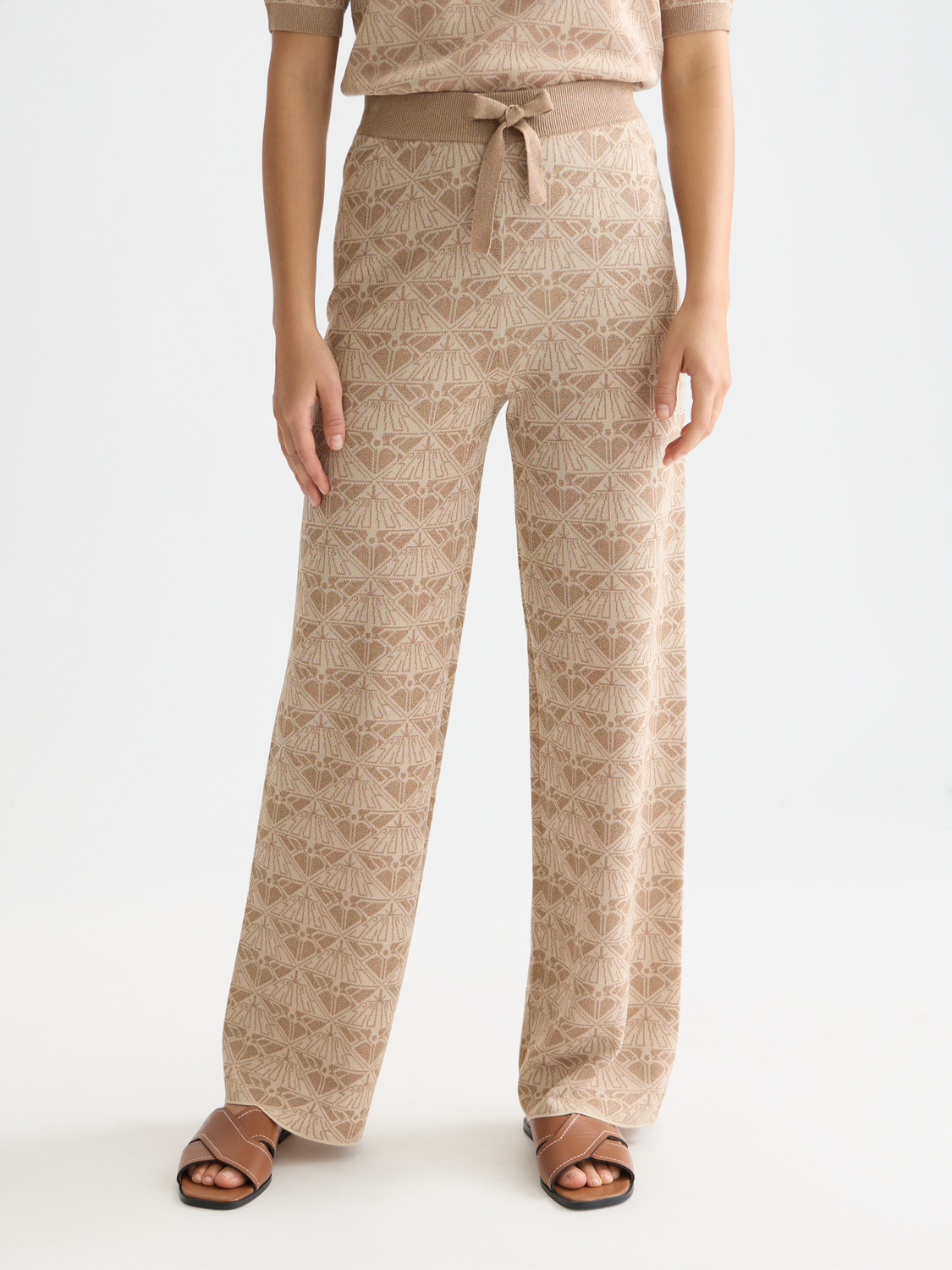 Jacquard knitted sweatpants by Scotch & Soda, featuring a stylish pattern and comfortable fit, shown on a model.