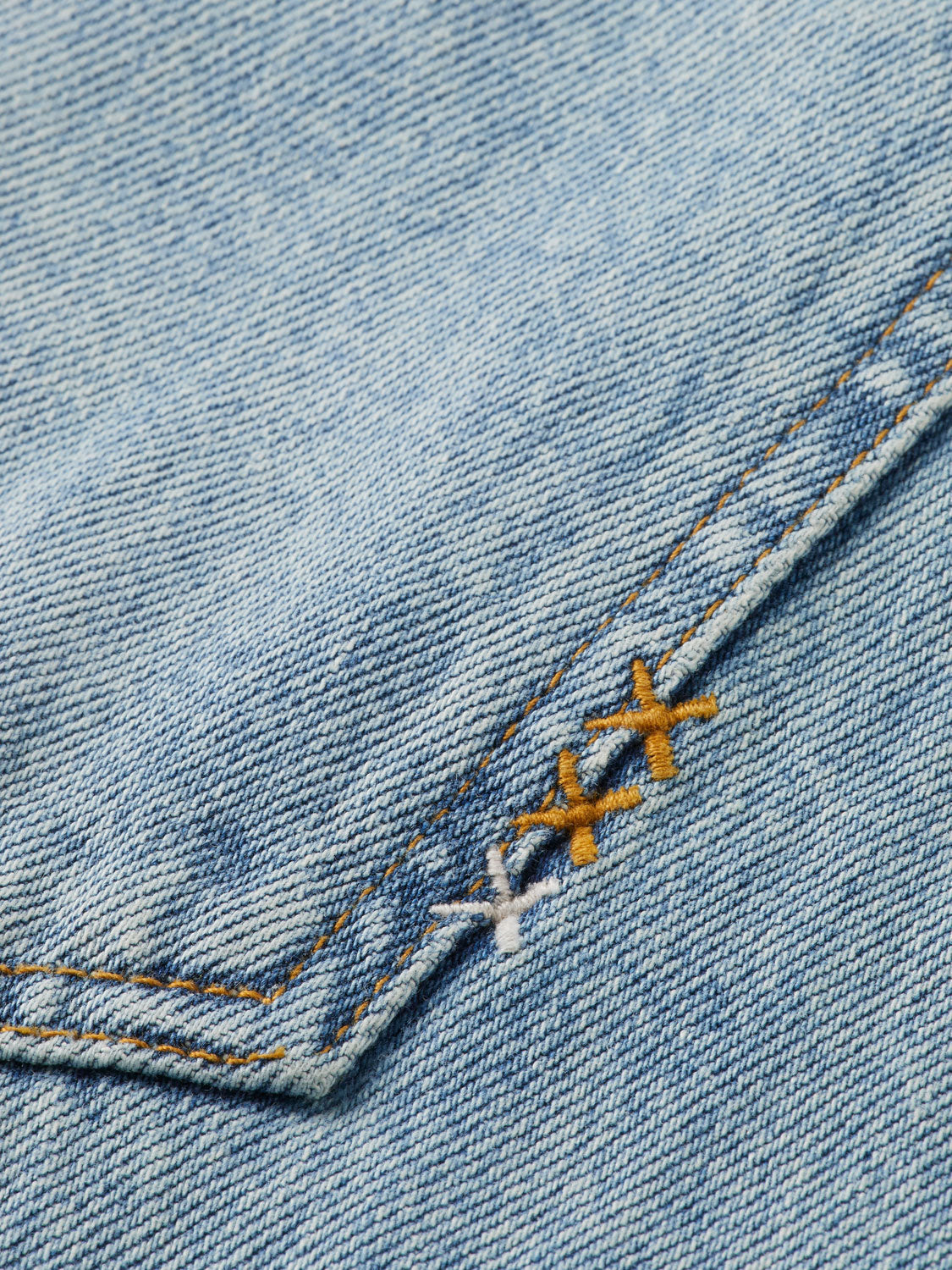 Scotch & Soda ripple straight-fit denim jeans hanging on a rack with visible stitching and classic five-pocket design.