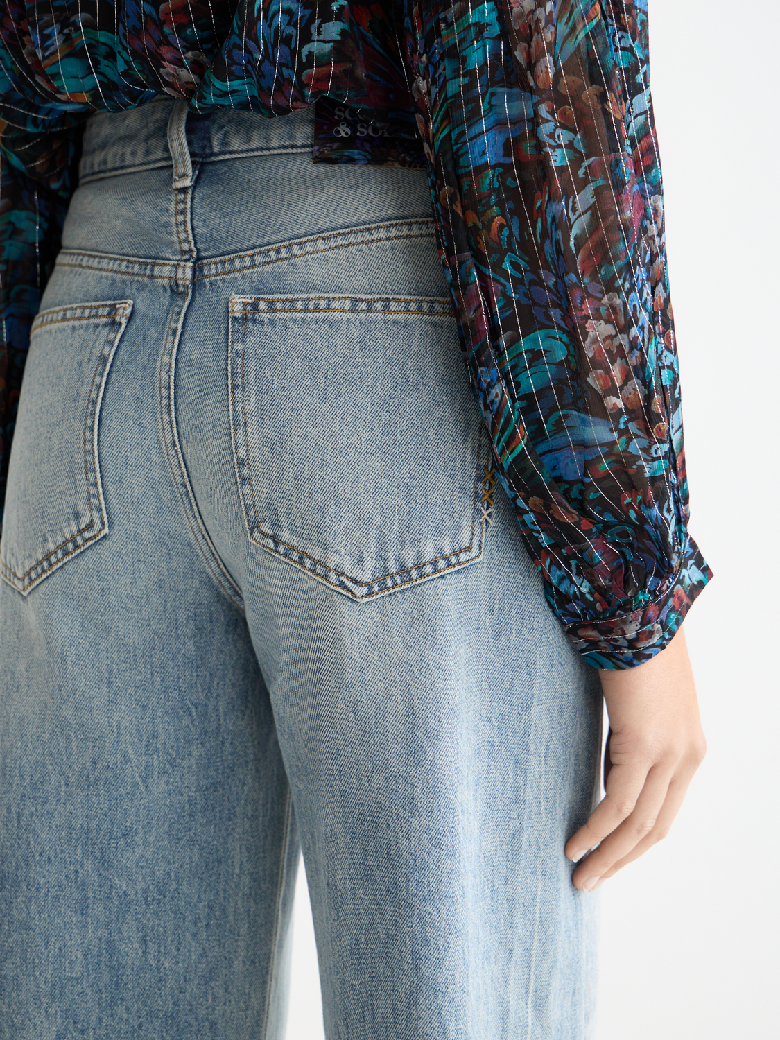Scotch & Soda Ripple straight-fit denim jeans displayed flat with classic five-pocket design and light blue wash.