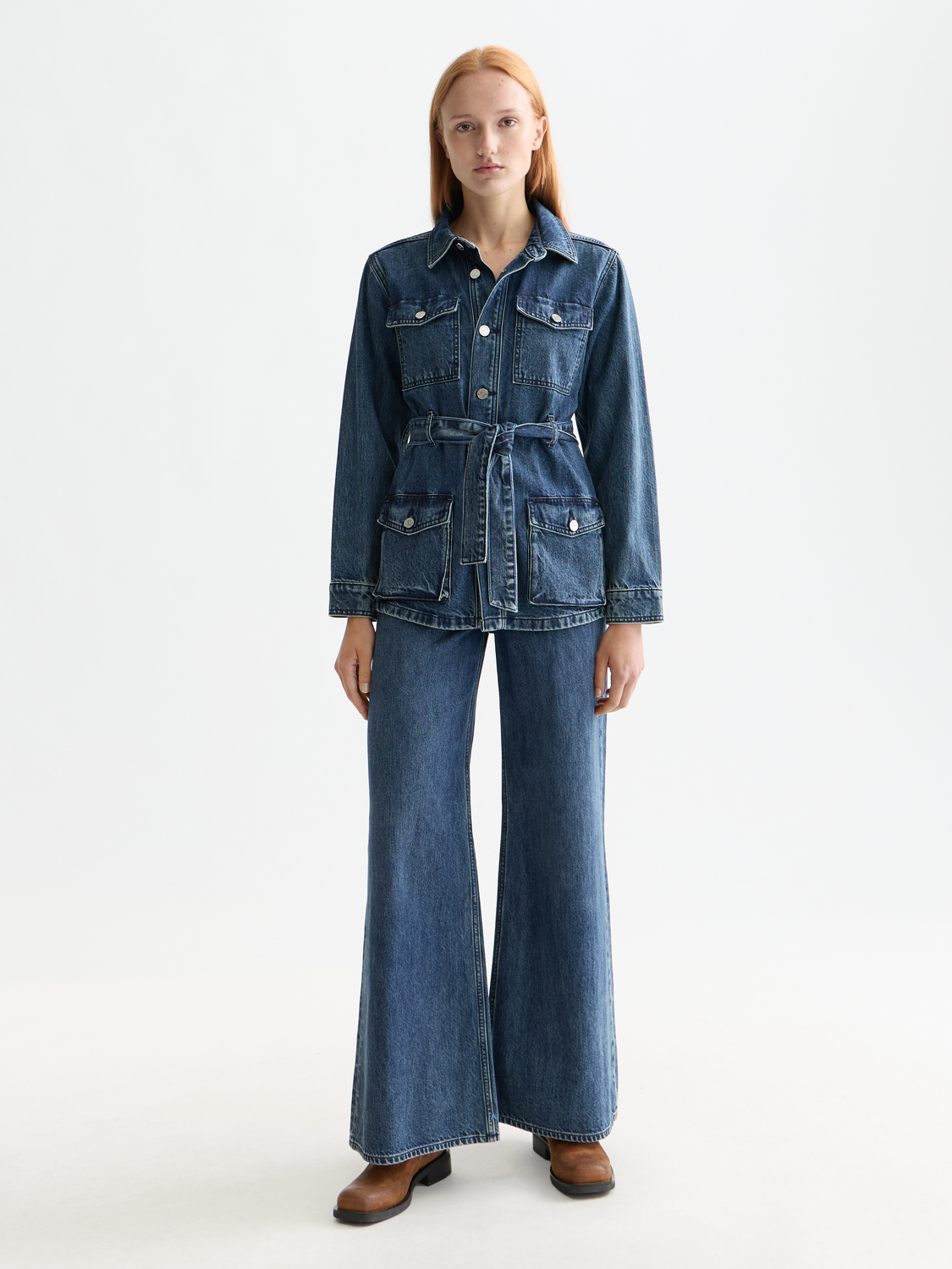 SCOTCH & SODA wide-fit denim jeans hanging on a rack, showcasing classic blue color and relaxed fit style.