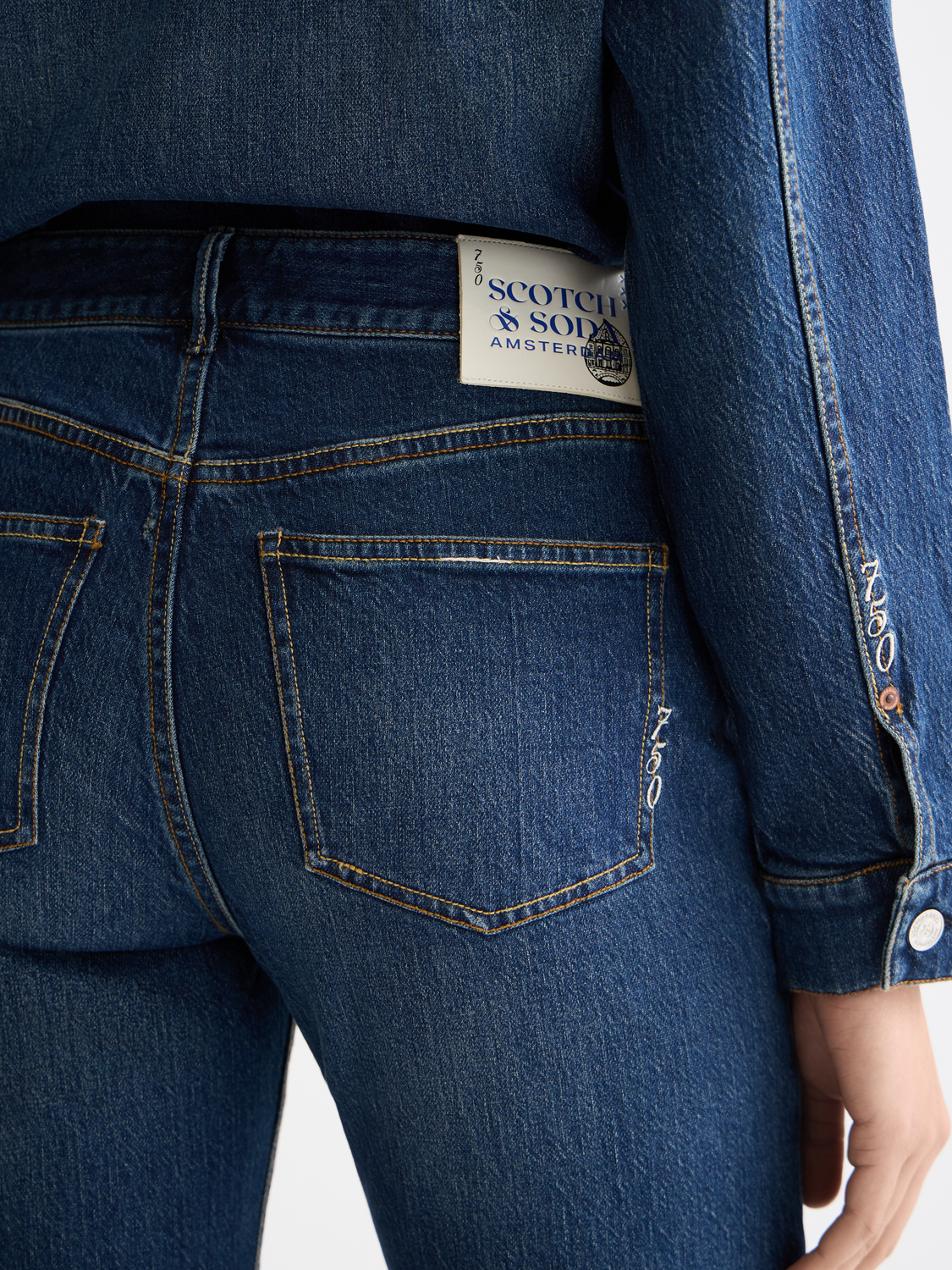 Sky straight-fit denim jeans by Scotch & Soda displayed on a model, showing the classic five-pocket design and light wash finish.