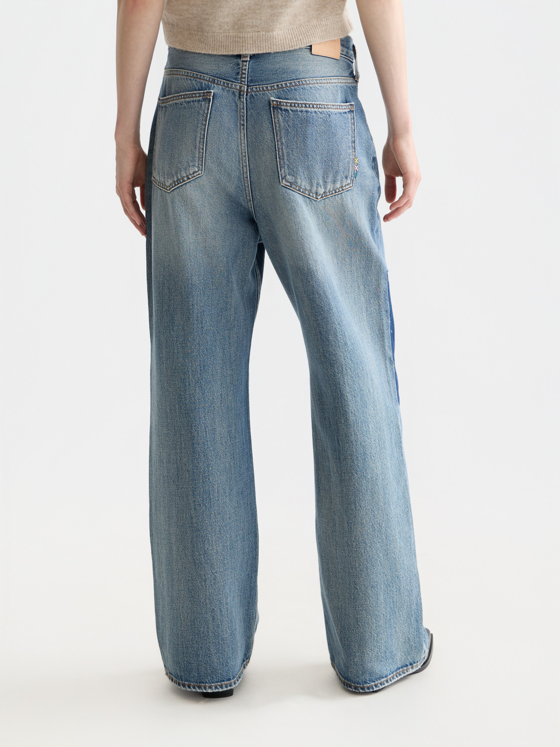 Deep loose-fit denim jeans by Scotch & Soda, shown from the back with a relaxed fit and classic stitching.