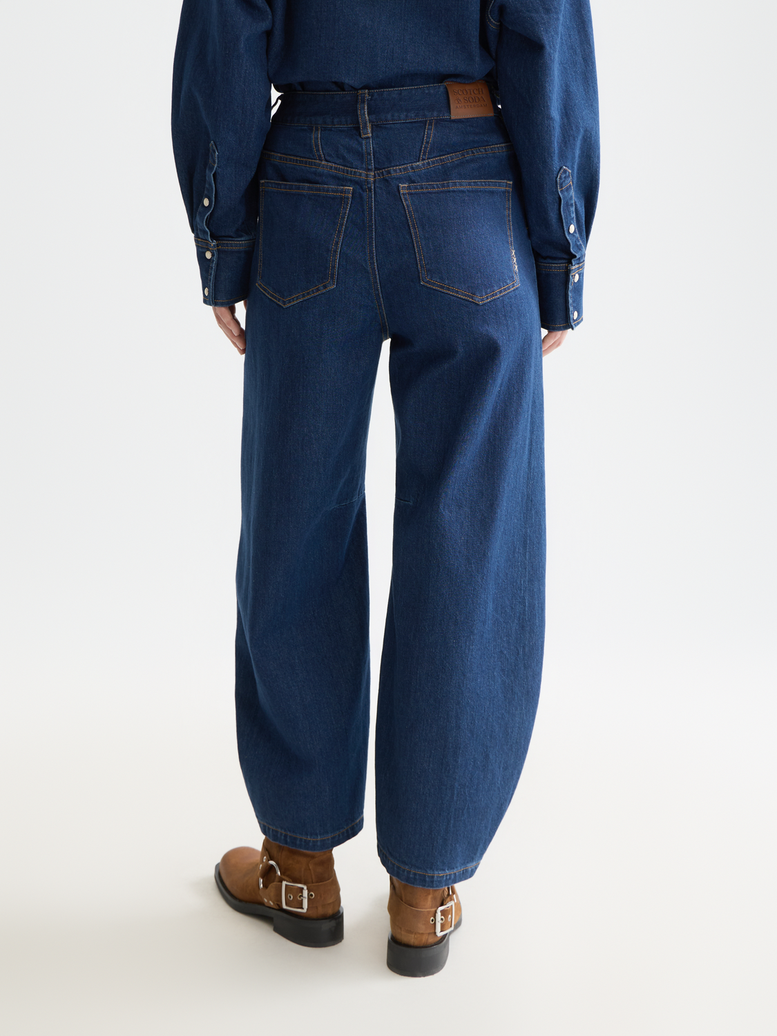 Back view of Scotch & Soda Loop barrel leg denim jeans on a model, showcasing relaxed fit and stylish design.