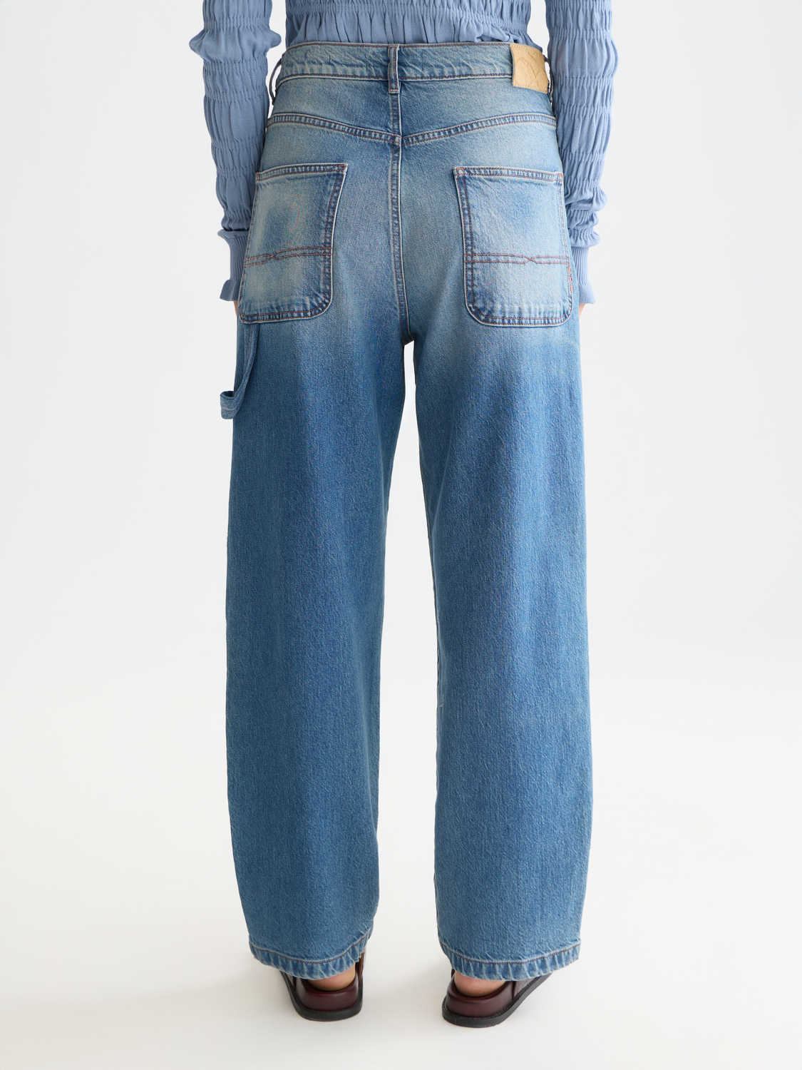 Scotch & Soda Raine wide-fit denim jeans shown from the back, featuring classic blue wash and relaxed fit.
