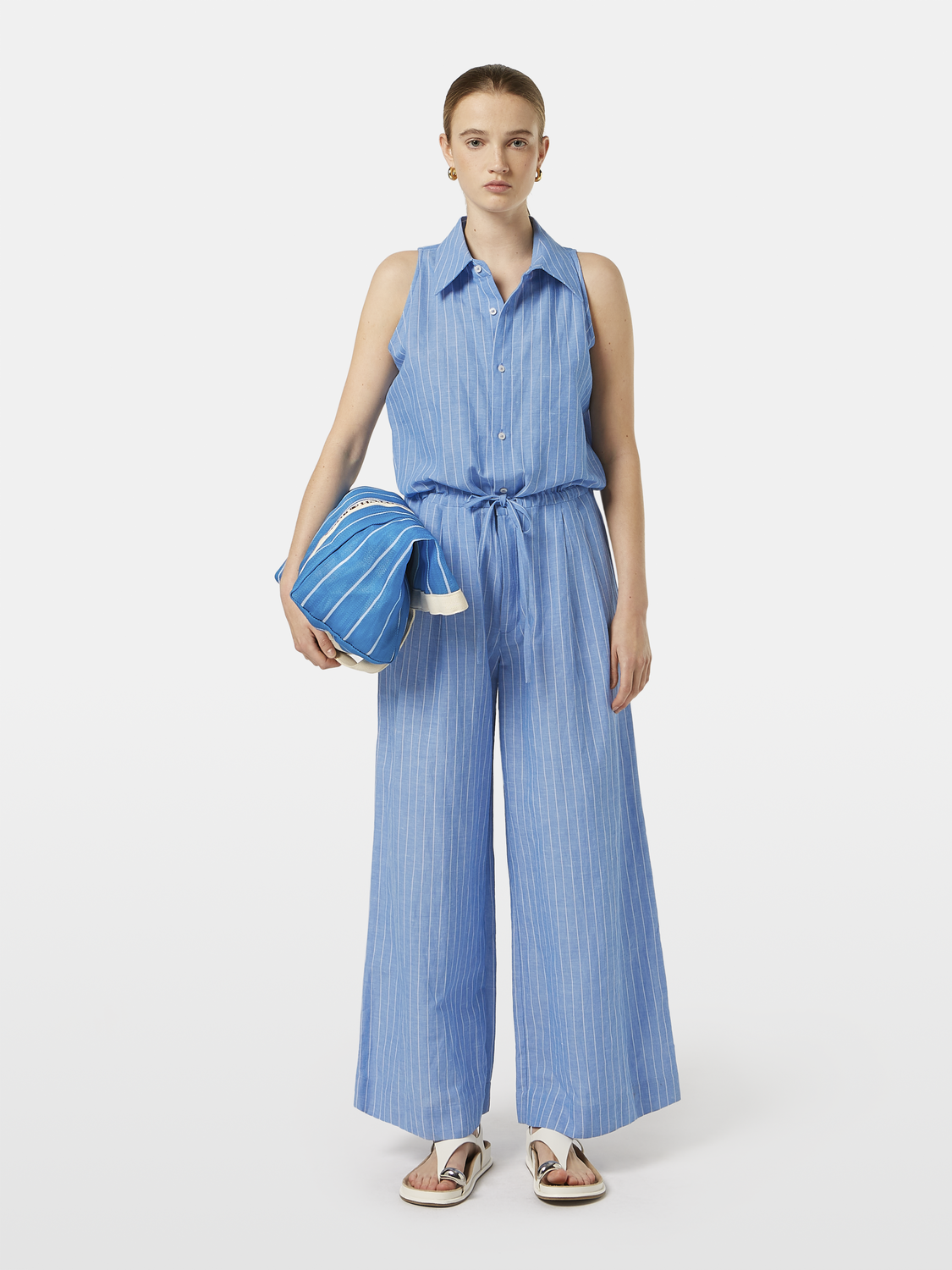 Striped linen jumpsuit by Scotch & Soda with a relaxed fit, featuring vertical stripes and a sleeveless design.