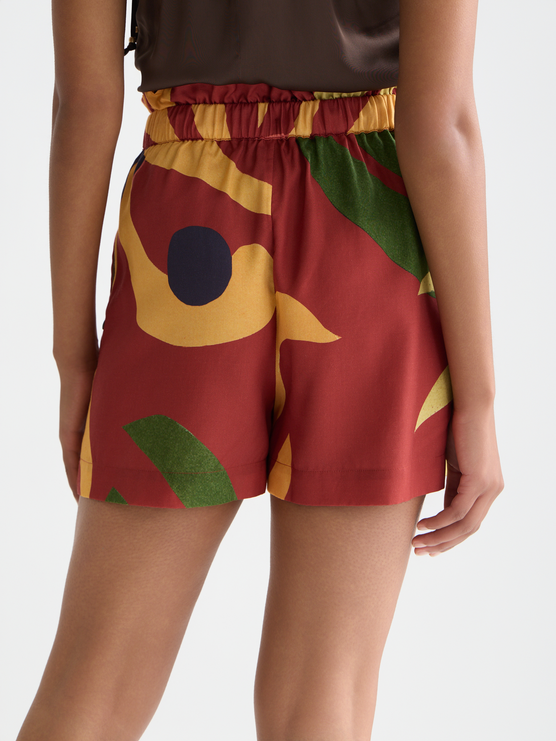 Printed Scotch & Soda shorts featuring vibrant patterns and a casual fit, displayed on a model against a neutral background.