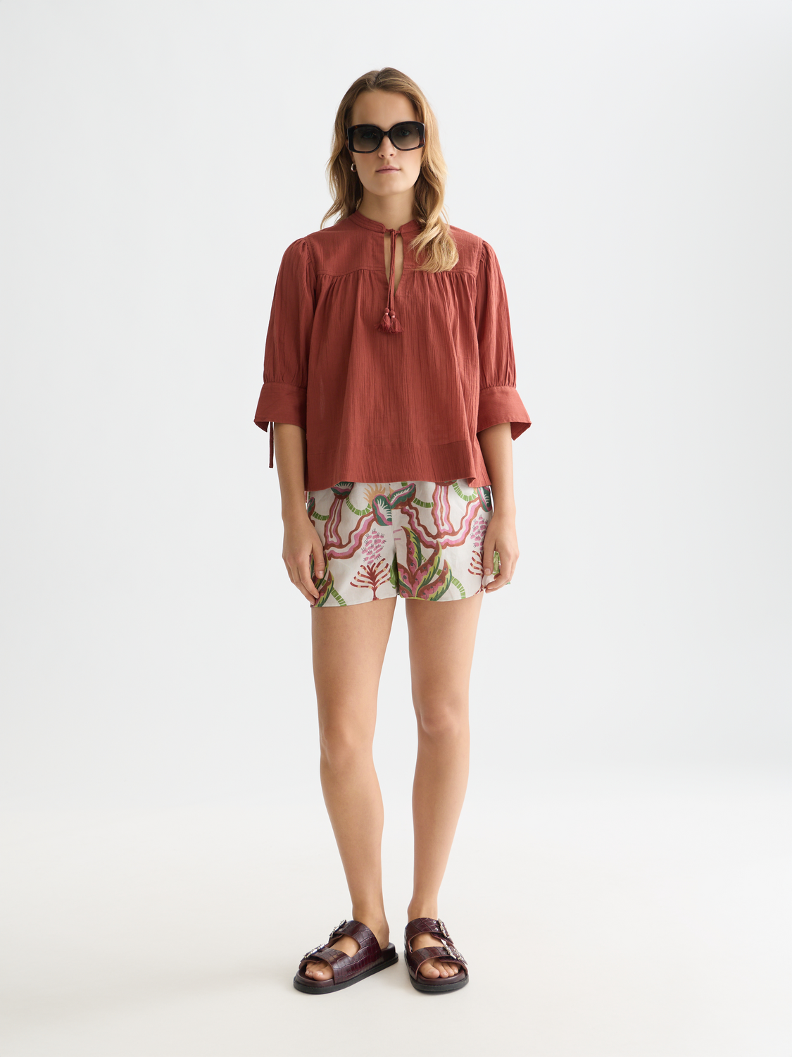 Light beige cotton-linen shorts from Scotch & Soda displayed on a model, featuring a relaxed fit and casual style.