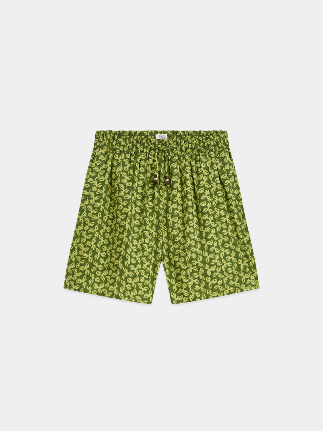 Printed shorts from Scotch & Soda featuring vibrant patterns and casual fit, shown on a model in a relaxed outdoor setting.