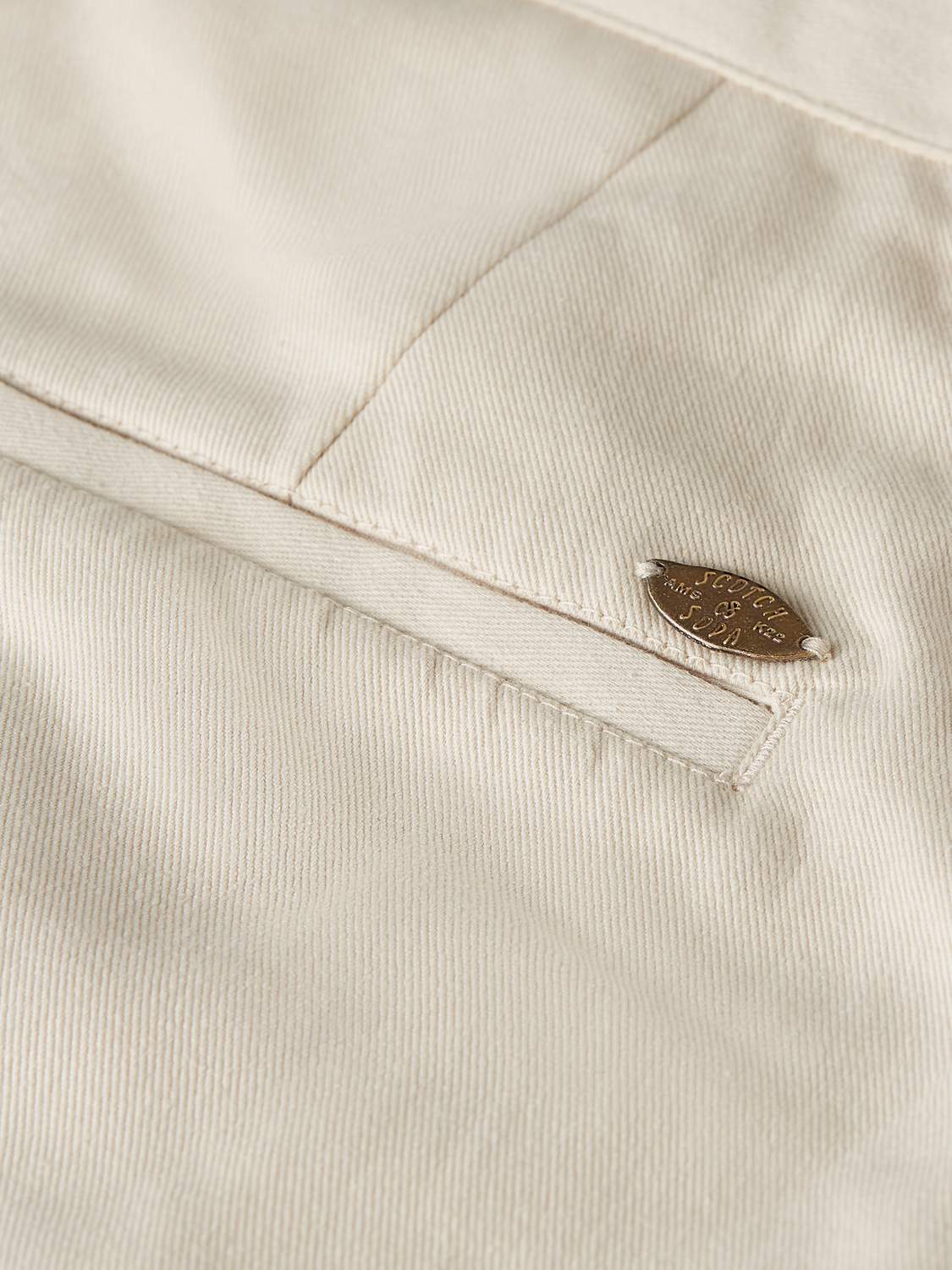 Embellished shorts by Scotch & Soda featuring intricate bead and sequin details on lightweight fabric.