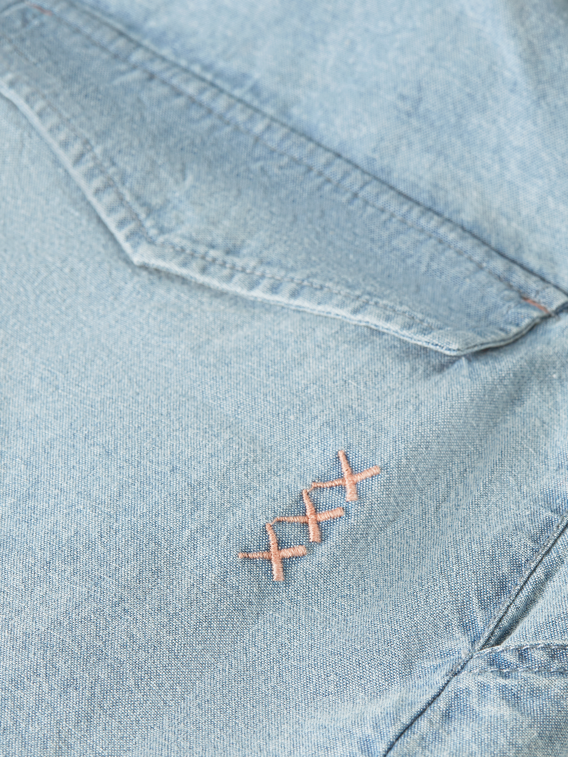 Pair of indigo denim shorts from Scotch & Soda with a classic fit and rolled hem, shown on a neutral background.